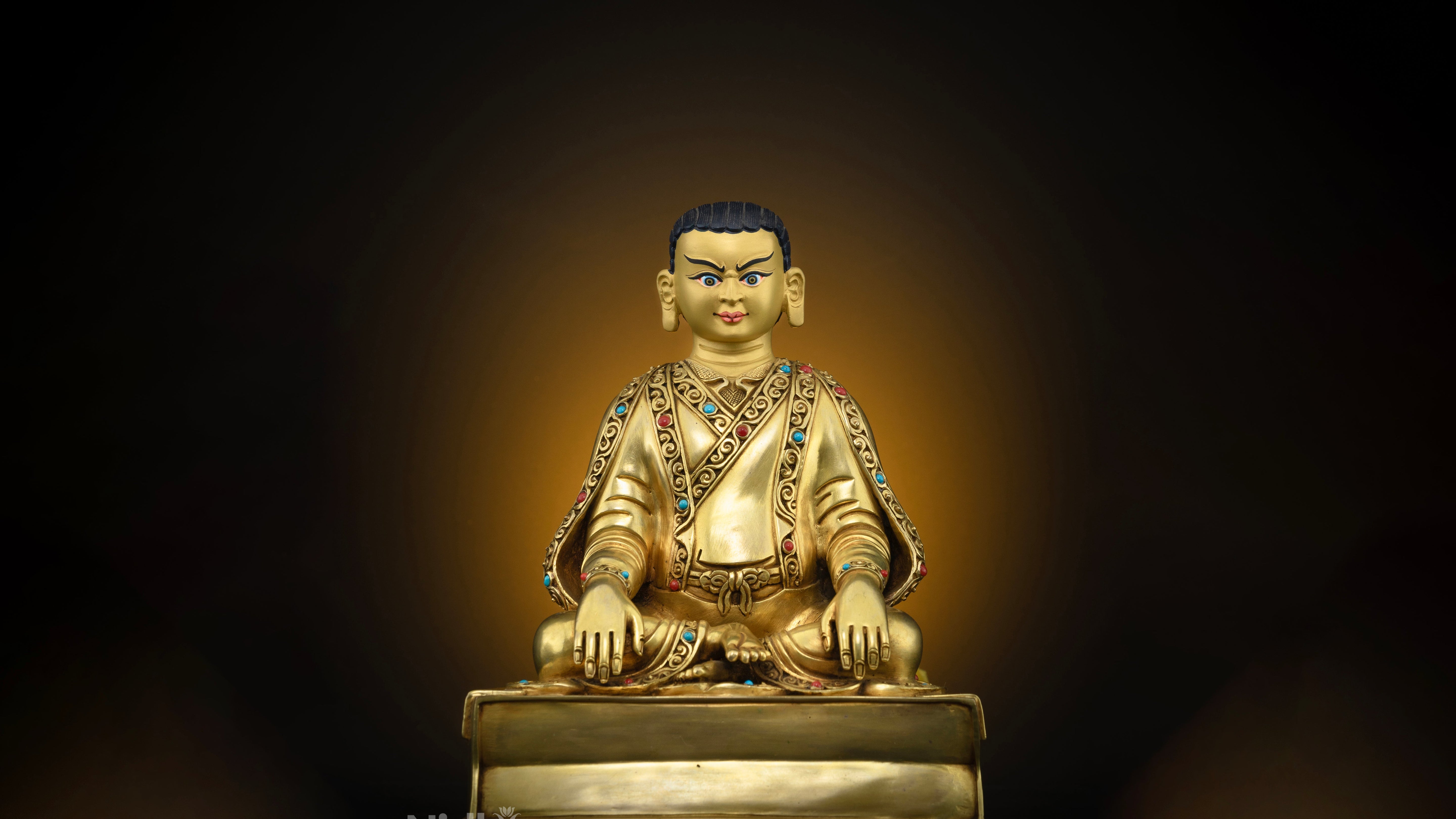 golden statue of Marpha adorned with gemstones and featuring hand carved details