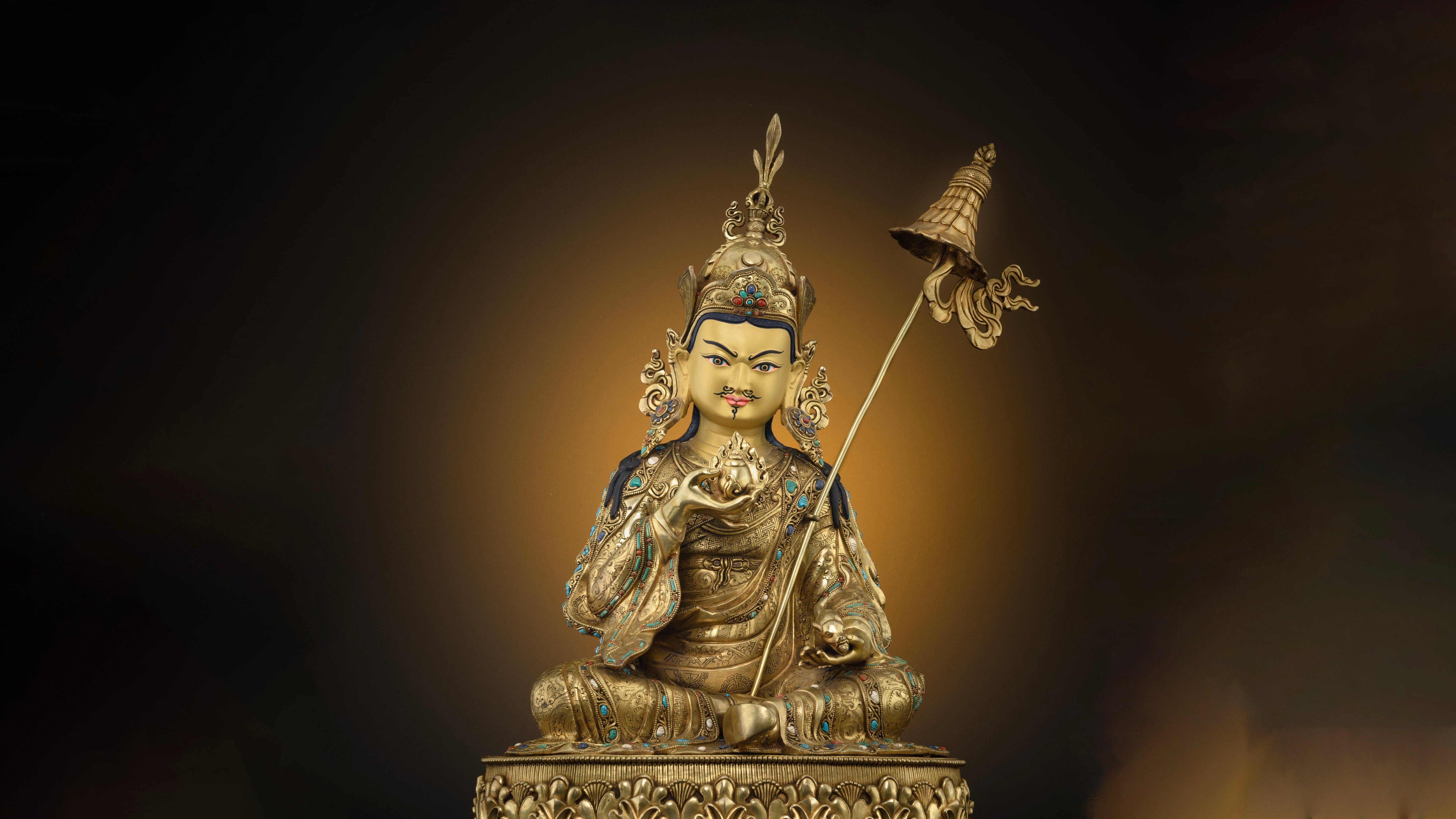 shiny golden statue of Guru Orgyen Norlha, The statue is durable because the base material used is copper upon which gold plating is done