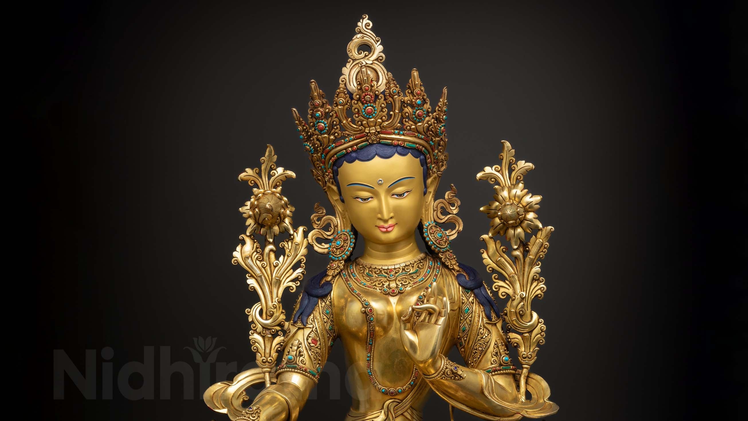vibrantly colored green tara statue with pure gold plated face and dark green skin with other colors to add accents