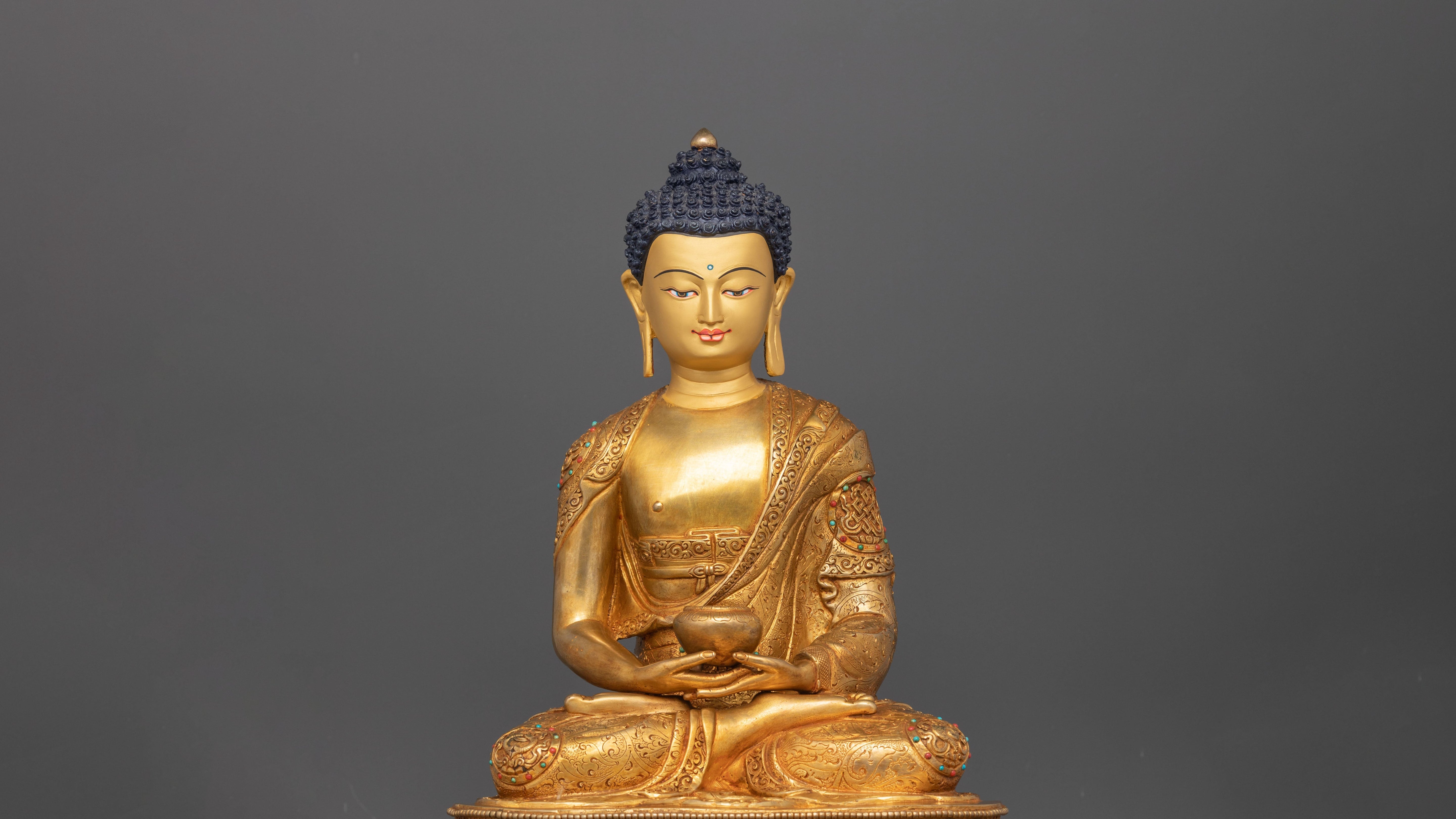 golden Ratnasambhava statue meditating while sitting on top of a Lotus seat with his arms making a Dhyana Mudra