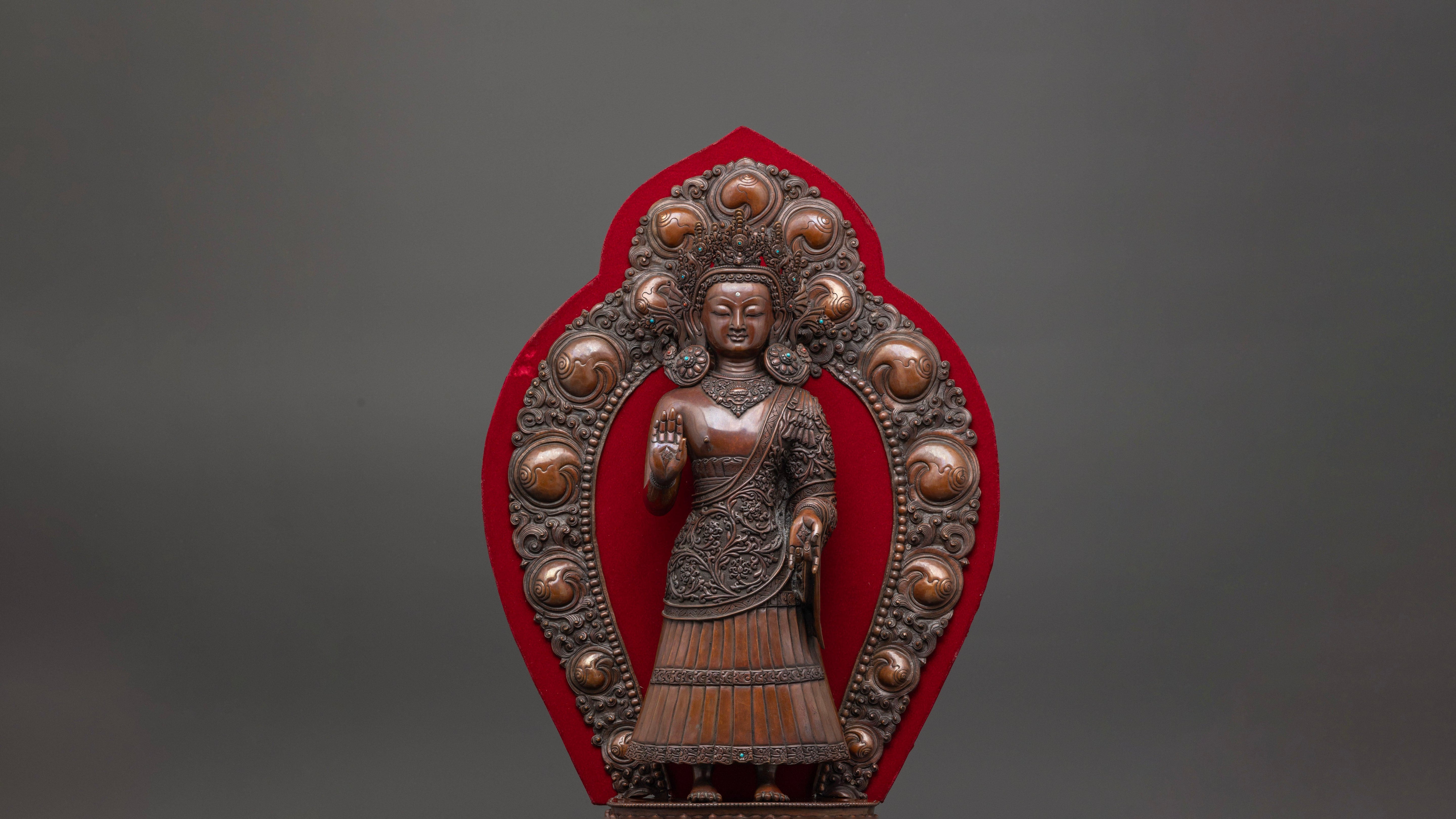 Brown colored copper made Dipankara Buddha Statue with red background