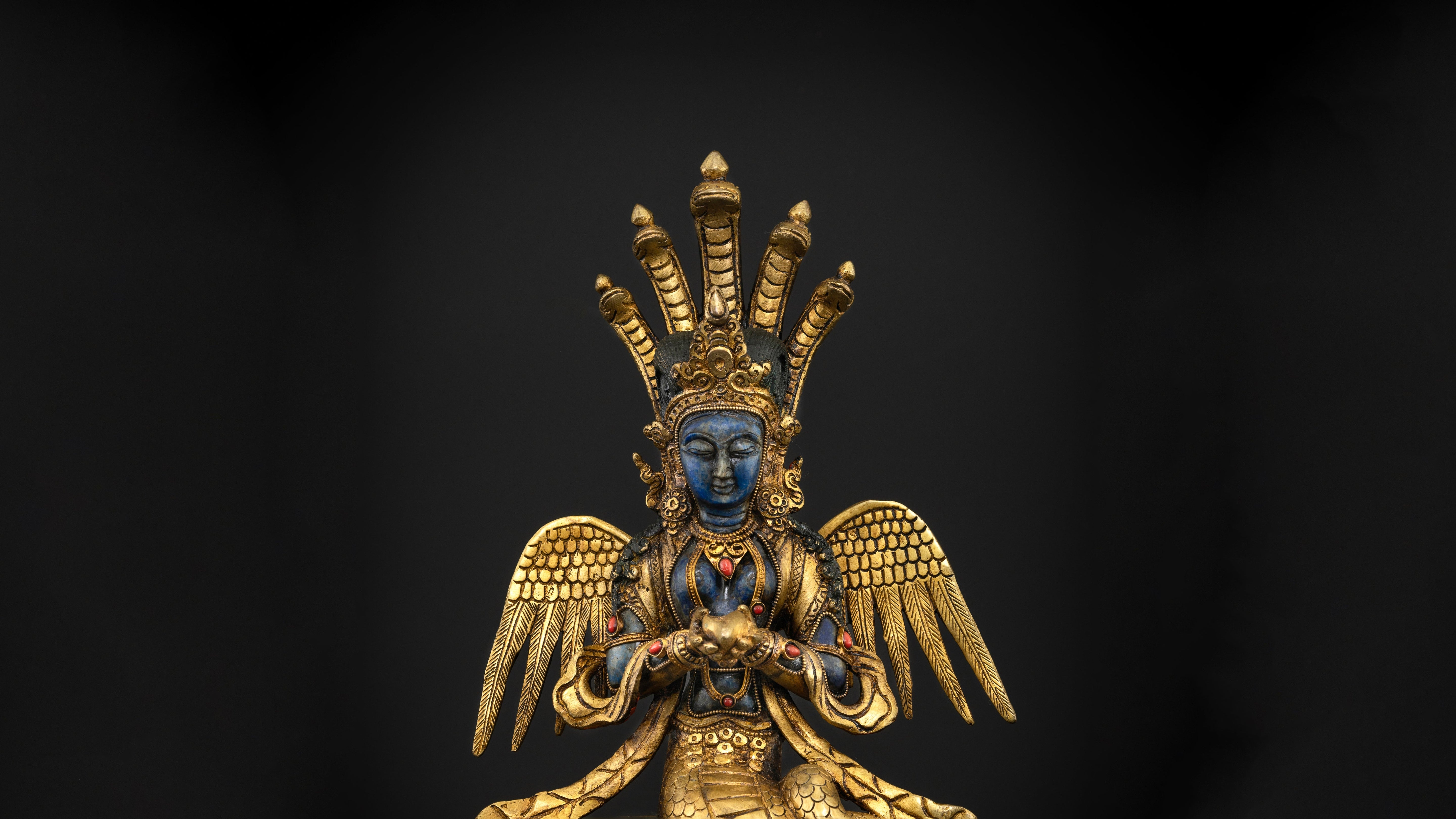golden nagkanya statue with blue skin and having golden wings