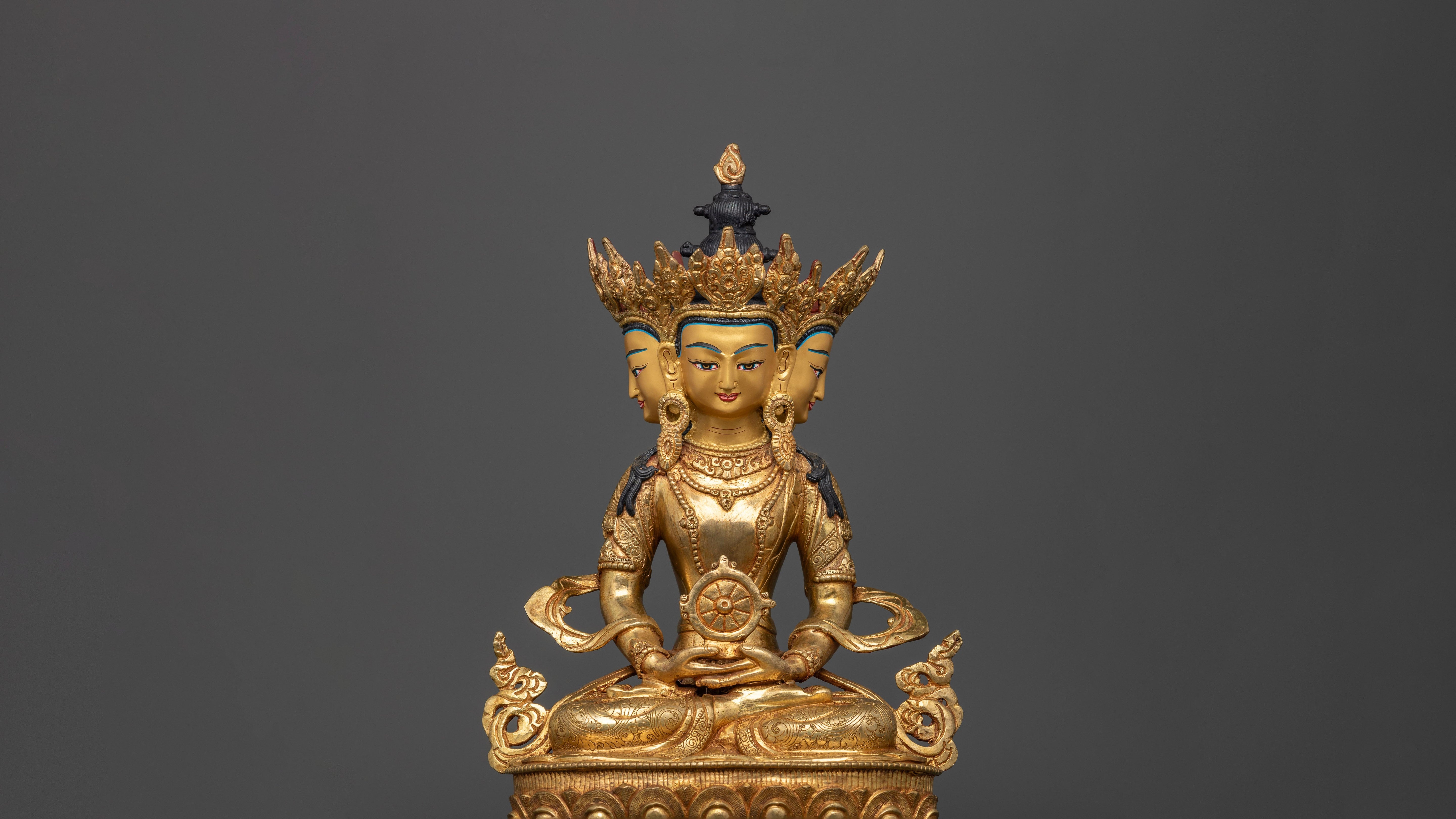 three faced gold plated Vairocana statue with intricate carvings and adorned with semi precious gemstones