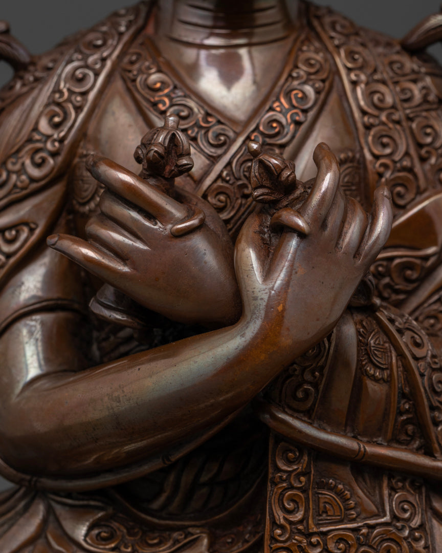 The oxidized statue of 16th karmapa statue holding bell in one hand and vajra in another representing the union of wisdom and compassion. | Decorative Buddhist statue of 16th Karmapa | Intricate 16th Karmapa statue design | Oxidized copper 16th Karmapa statue
