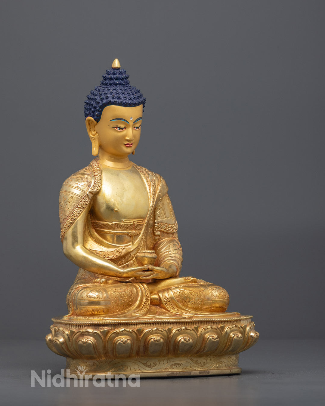 Amitabha Buddha statue with intricate monk robe and vivid acrylic colors on hair eyes and body