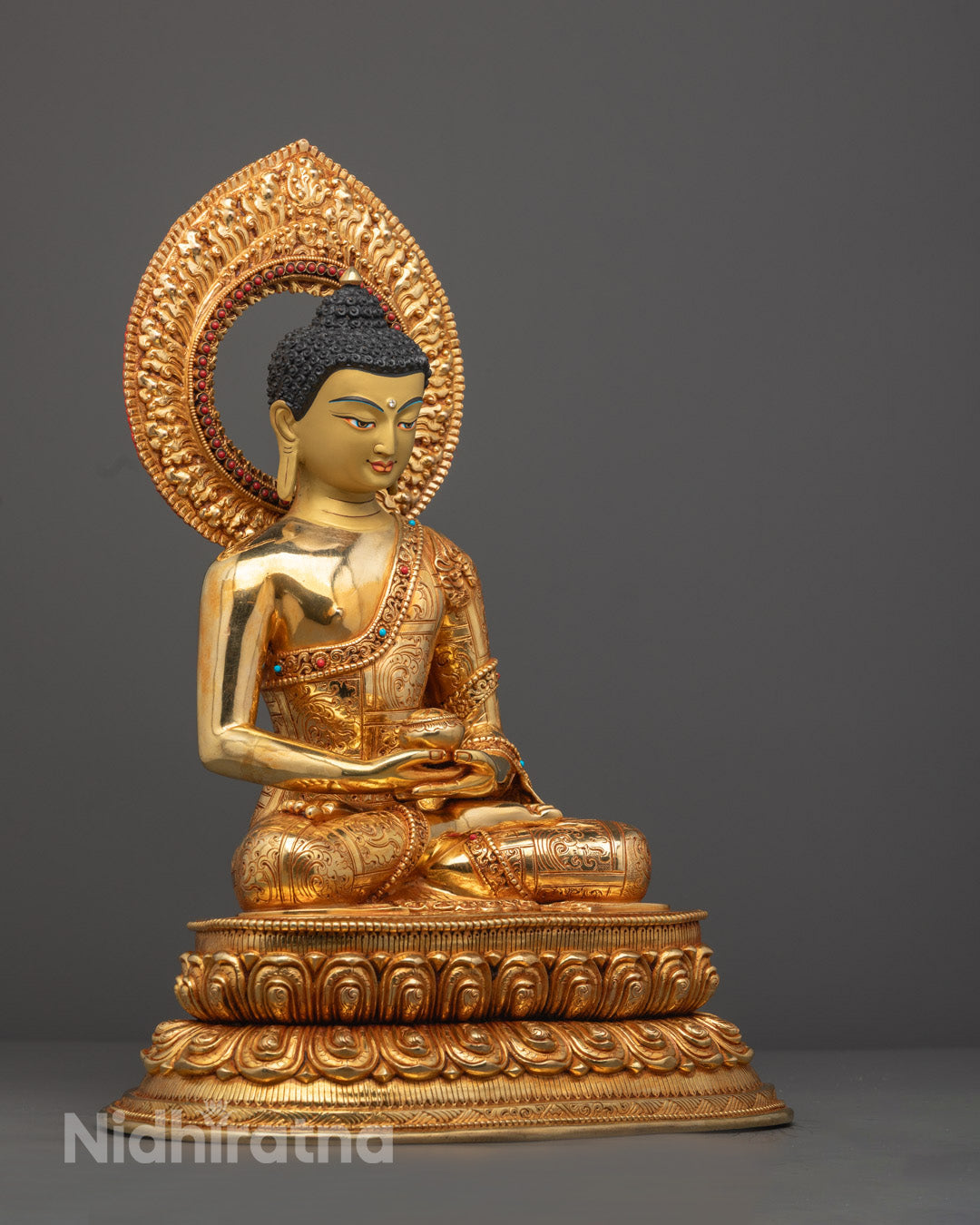 Close-up of Amitabha statue's lotus throne adorned with turquoise, coral and lapis lazuli inlays