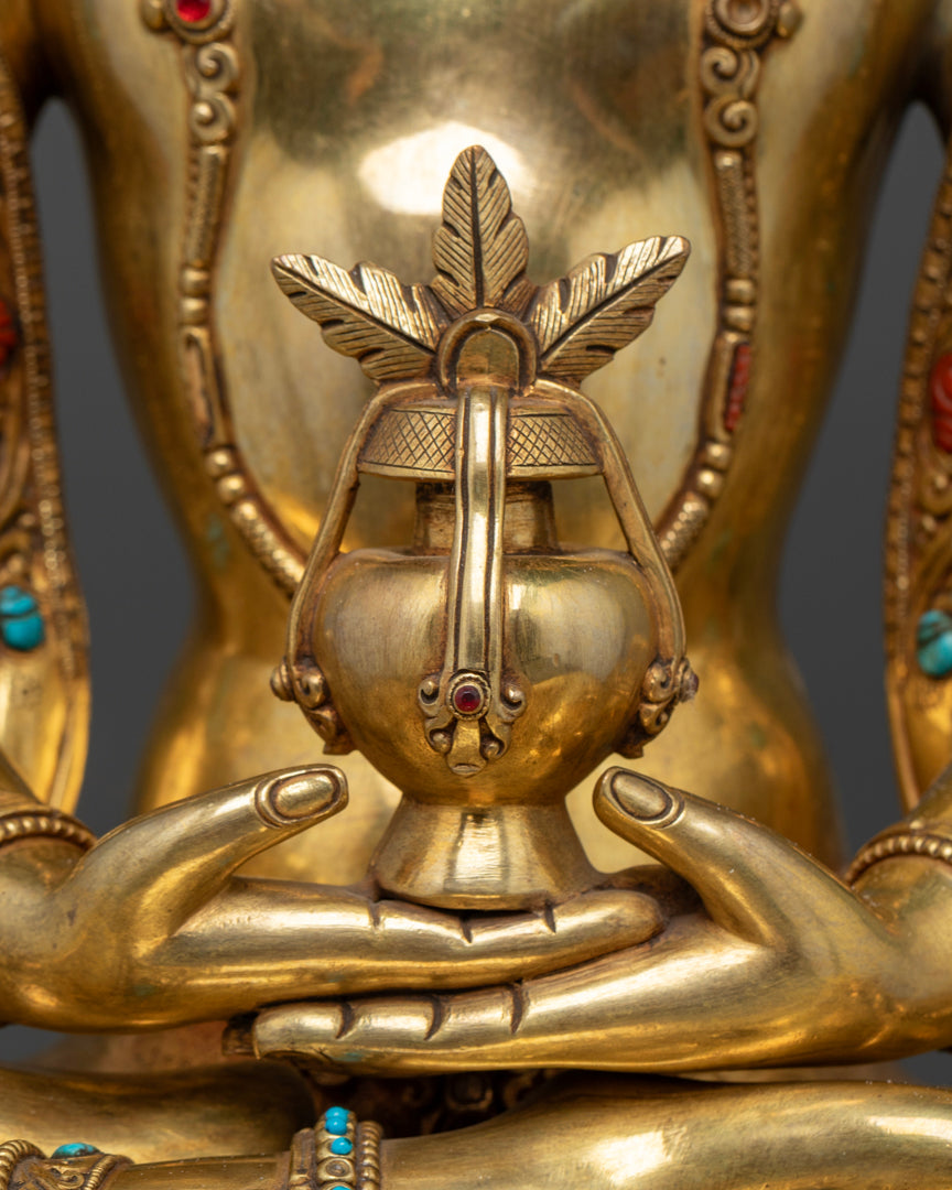 the gold plated Amitayus statue holding a long life vase which are folded in the mudra of meditative concentration. | Meditation Buddha figurine | Amitayus Buddha statue for tranquility