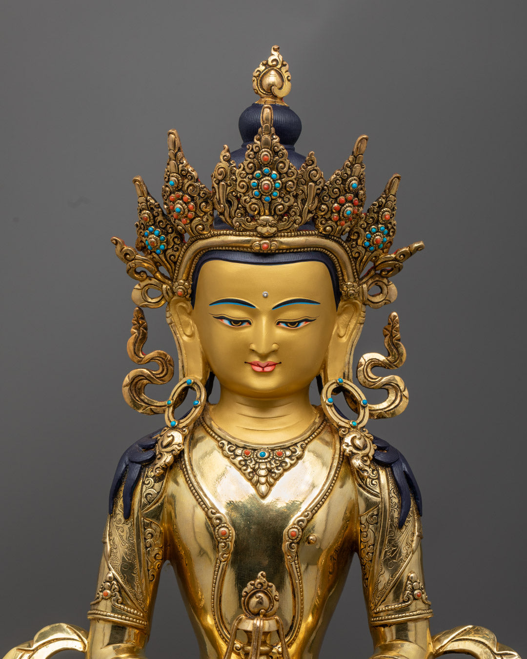 Amitayus statue's face and long-life vase, showcasing fine Nepalese craftsmanship and radiant gold gilding