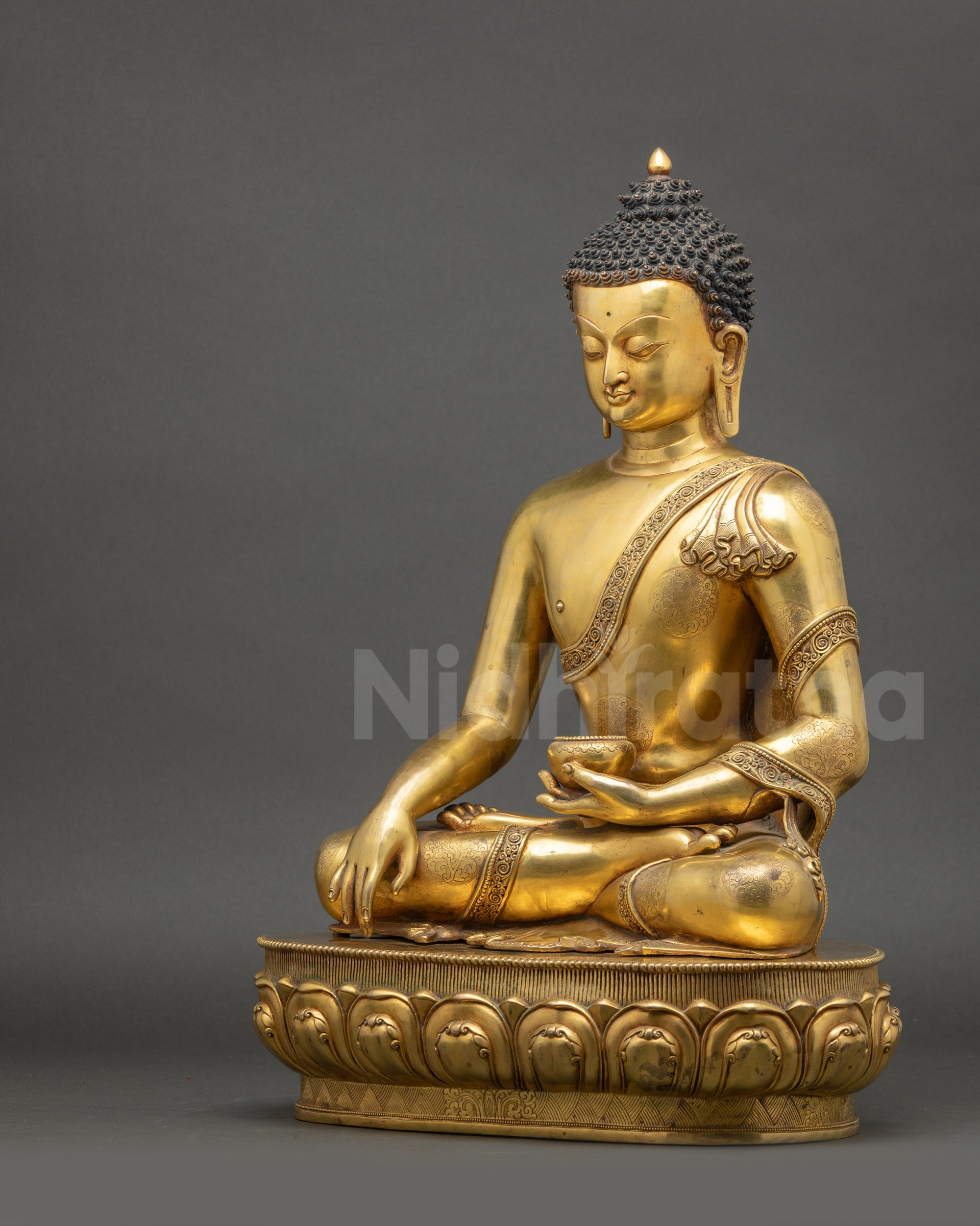 Angled side view of Shakyamuni Buddha sculpture showing earth-touching mudra and patra bowl