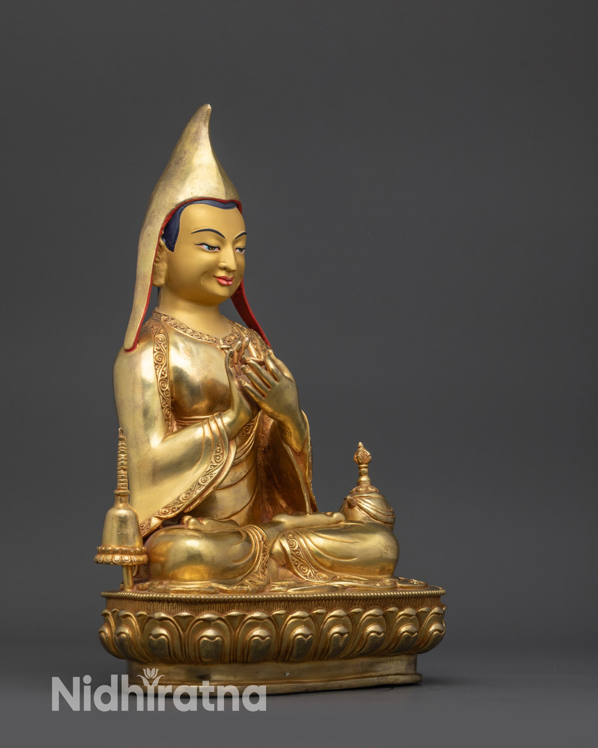 Atisha statue right side view with intricate robes and vajra-crowned stupa