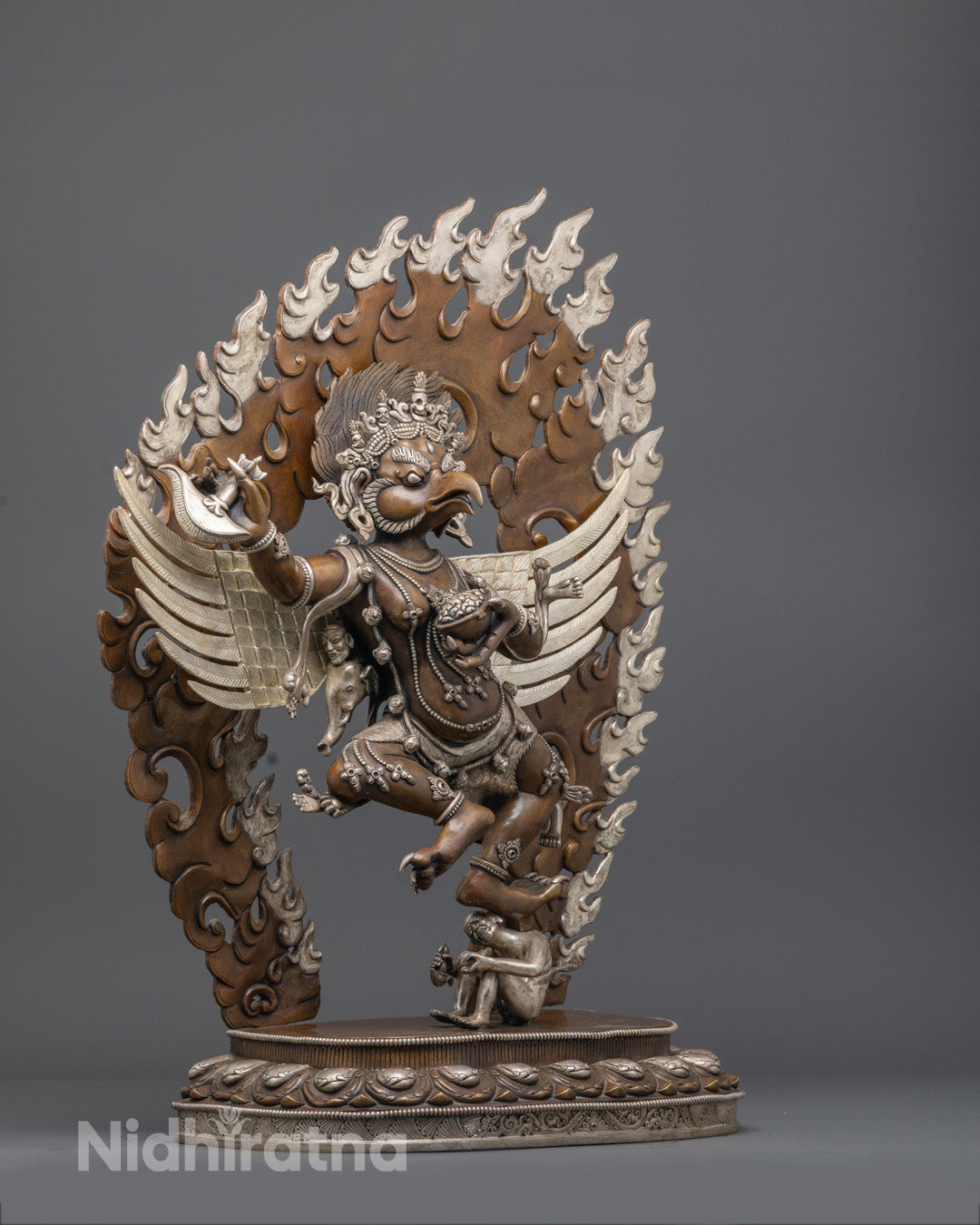 Authentic Nepalese Garuda statue with silver plating and hand-painted accents, perfect for spiritual altars