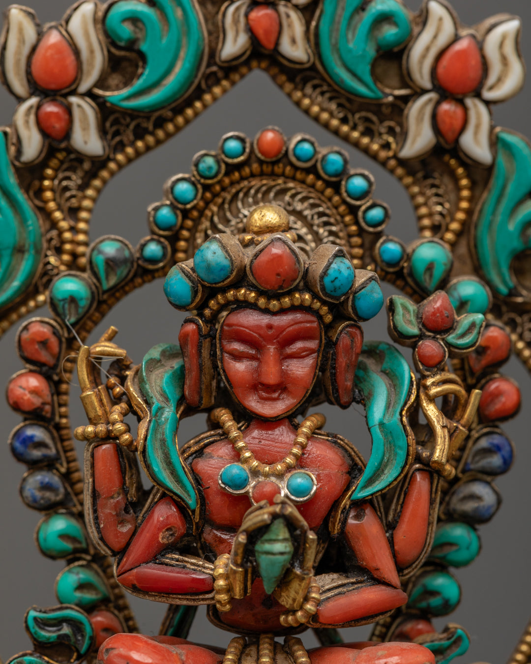 Avalokiteshvara’s halo and crown adorned with turquoise, coral, and lapis lazuli semi-precious stones