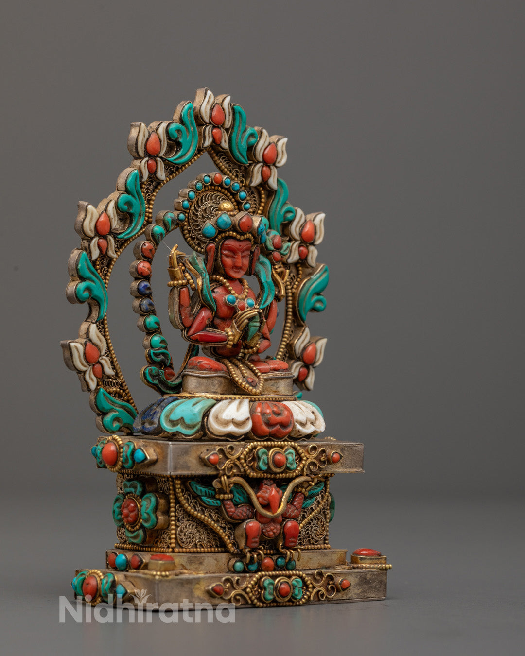 Avalokiteshvara statue highlighting flowing robe and intricate carvings decorated with shimmering gems