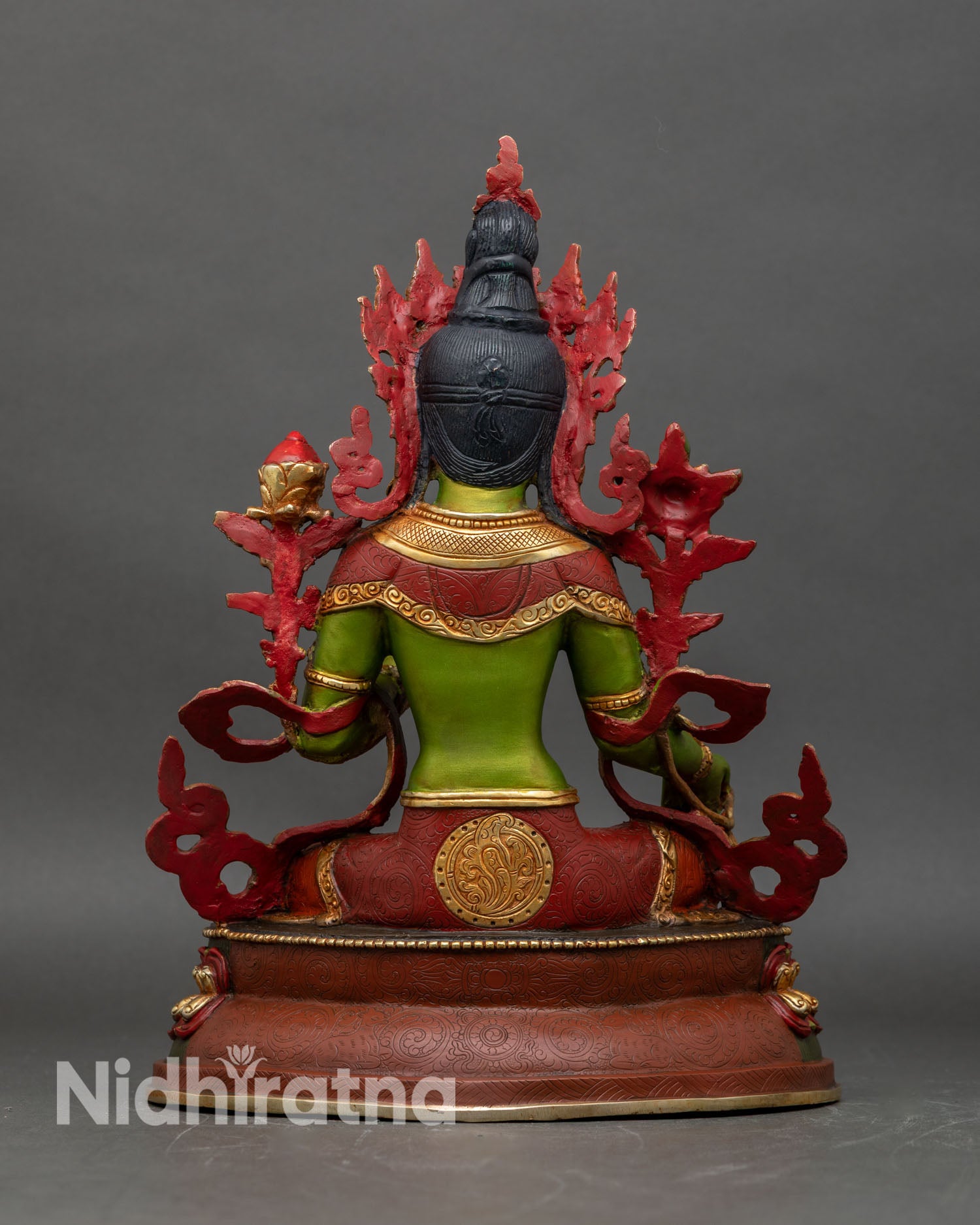 Back view of Green Tara statue, ornate carvings and lotus throne details
