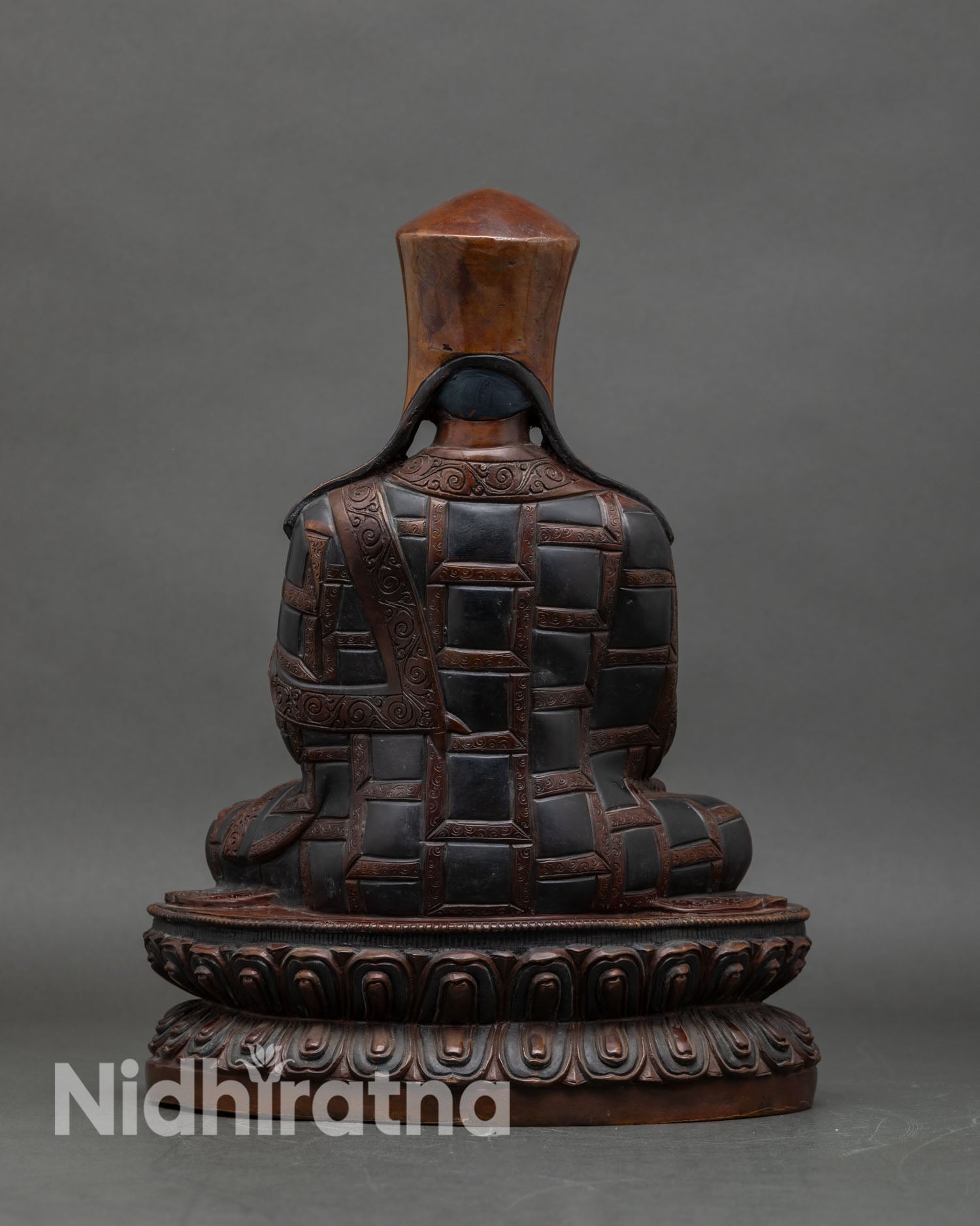 Back view of Karmapa Statue, intricate detailing, oxidized copper, Newari artisan craft