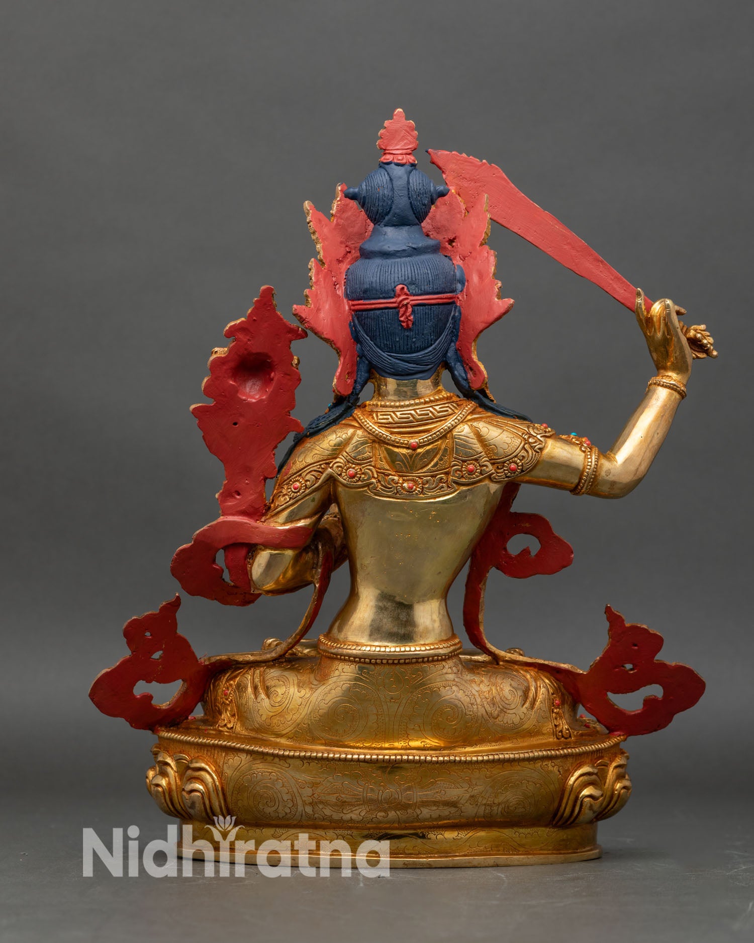Back view of Manjushri statue golden robes lotus pedestal hand-carved Himalayan sculpture