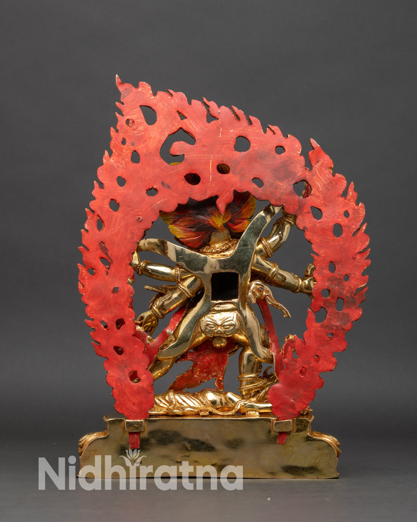 Side view Six-Armed Mahakala statue tiger skin crown of skulls ritual implements