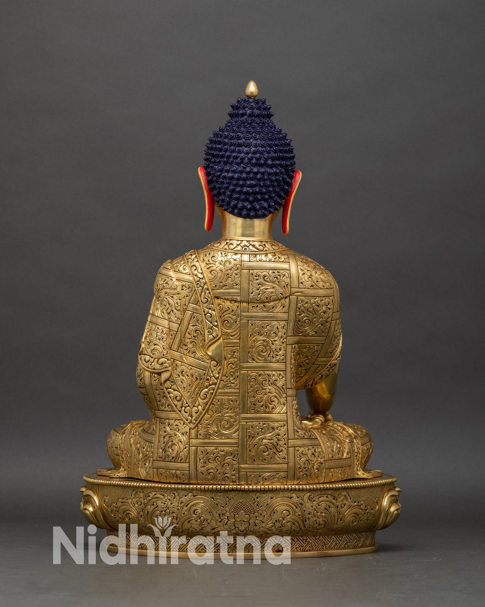 Back view of Shakyamuni Buddha statue, detailed lotus throne and traditional Nepalese patterns