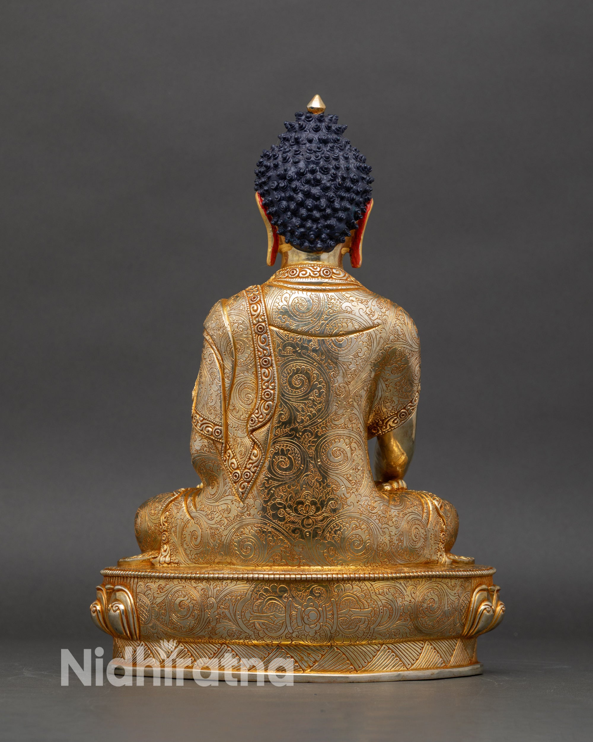 Back view of Shakyamuni Buddha statue highlighting engraved robes and artisan craftsmanship