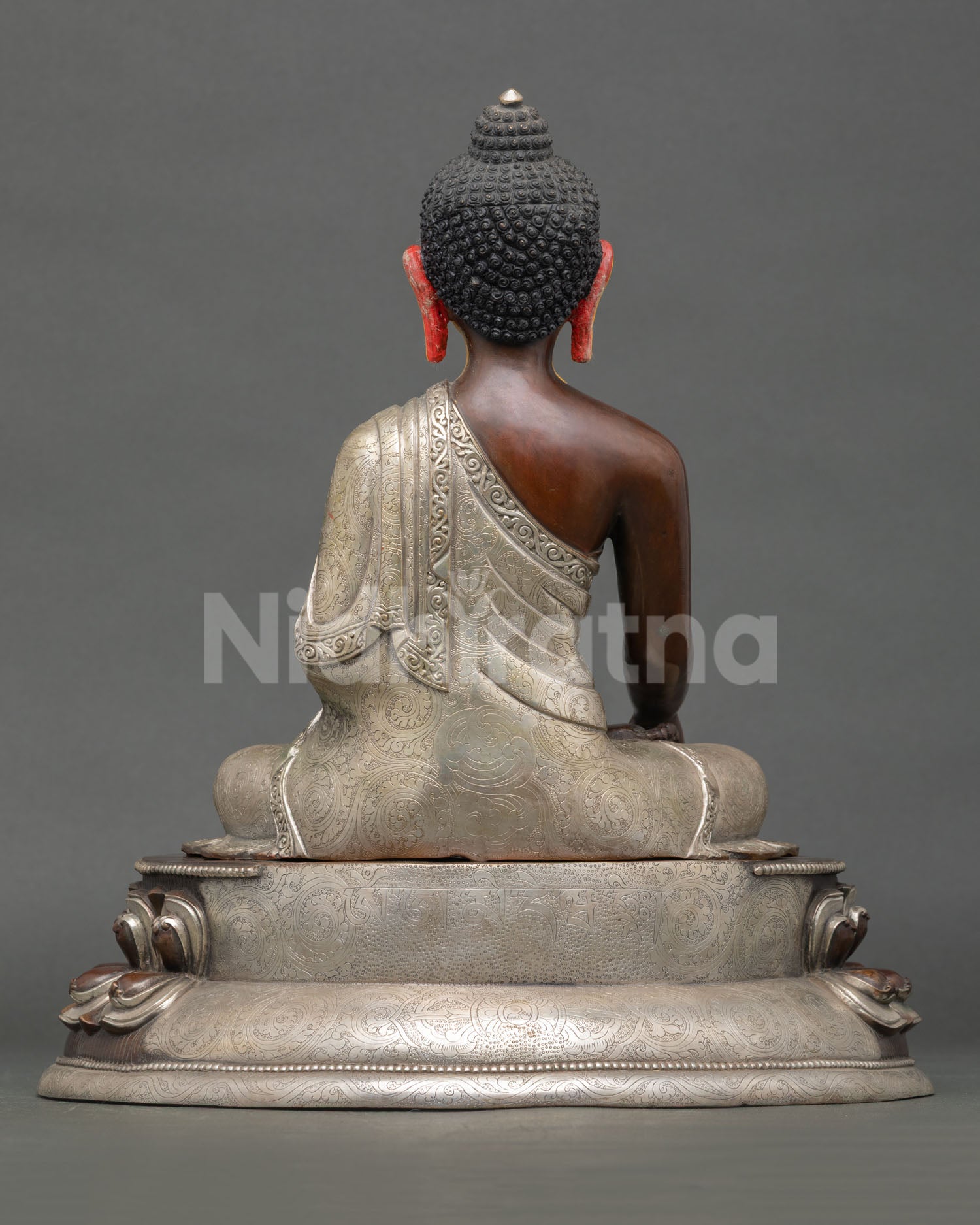 Back view of Shakyamuni Buddha statue showing detailed robe engravings and traditional Nepalese artistry