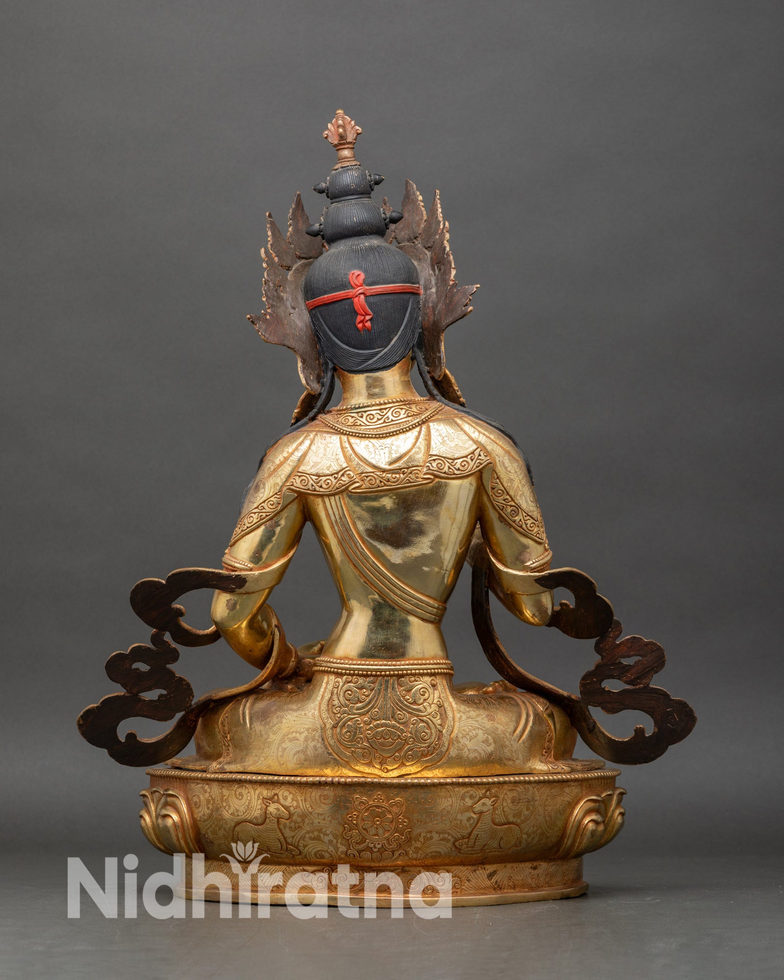 Back view of Vajrasattva Buddhist statue with detailed robe carving and lotus pedestal