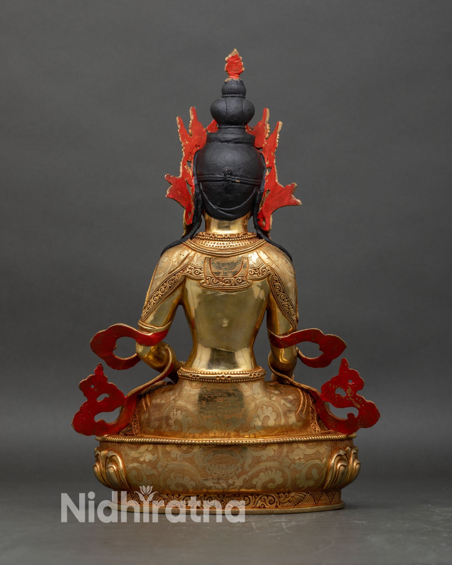 Back view of crowned Shakyamuni Buddha statue showing robe folds and rear crown detailing