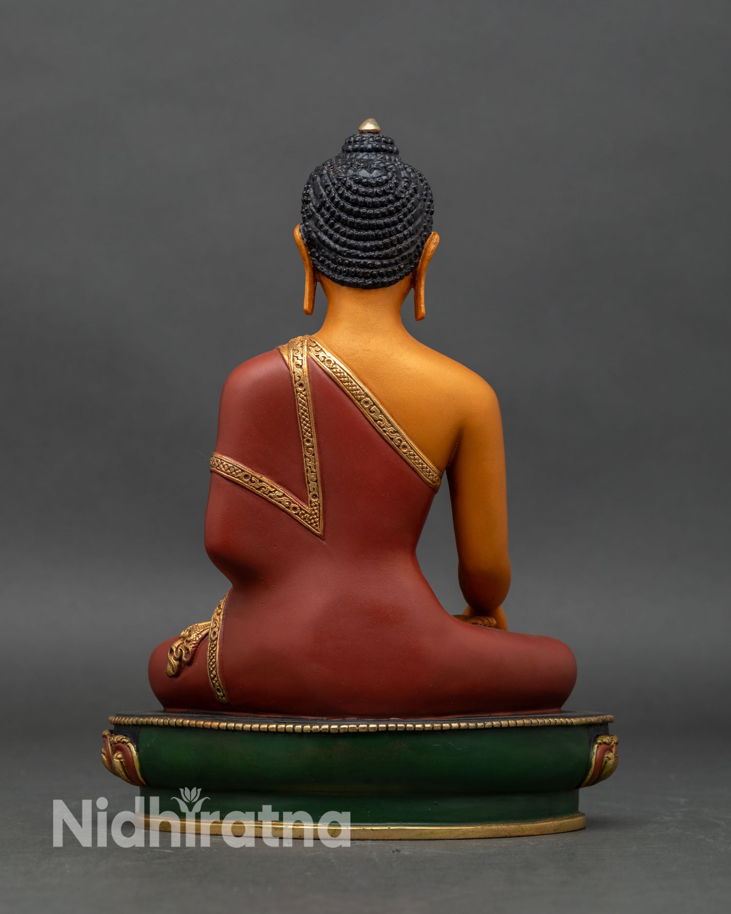 Back view of Shakyamuni Buddha statue, intricate carvings on lotus throne and robe