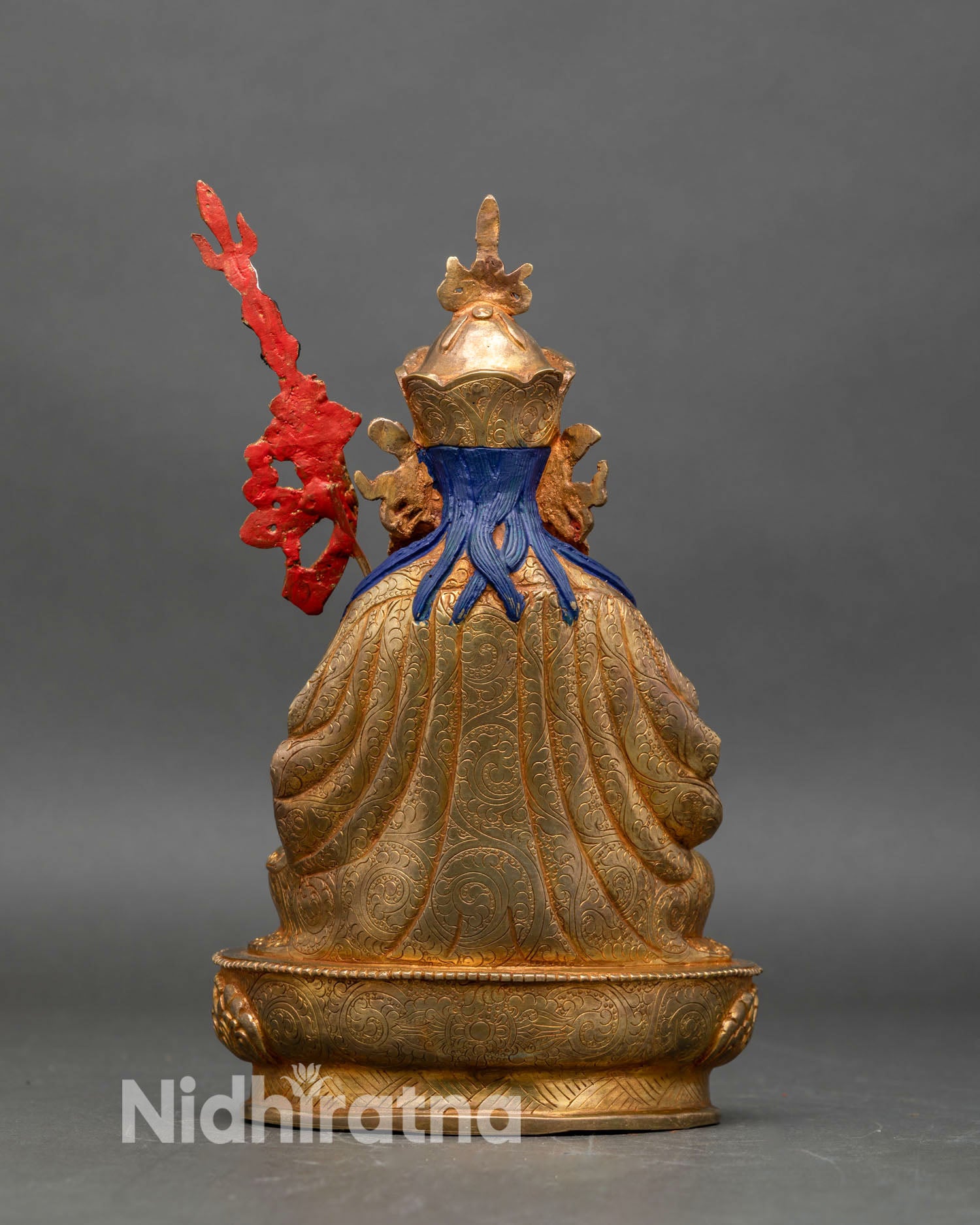 Back view of Tsokye Dorje statue with detailed robe carvings and sacred staff design