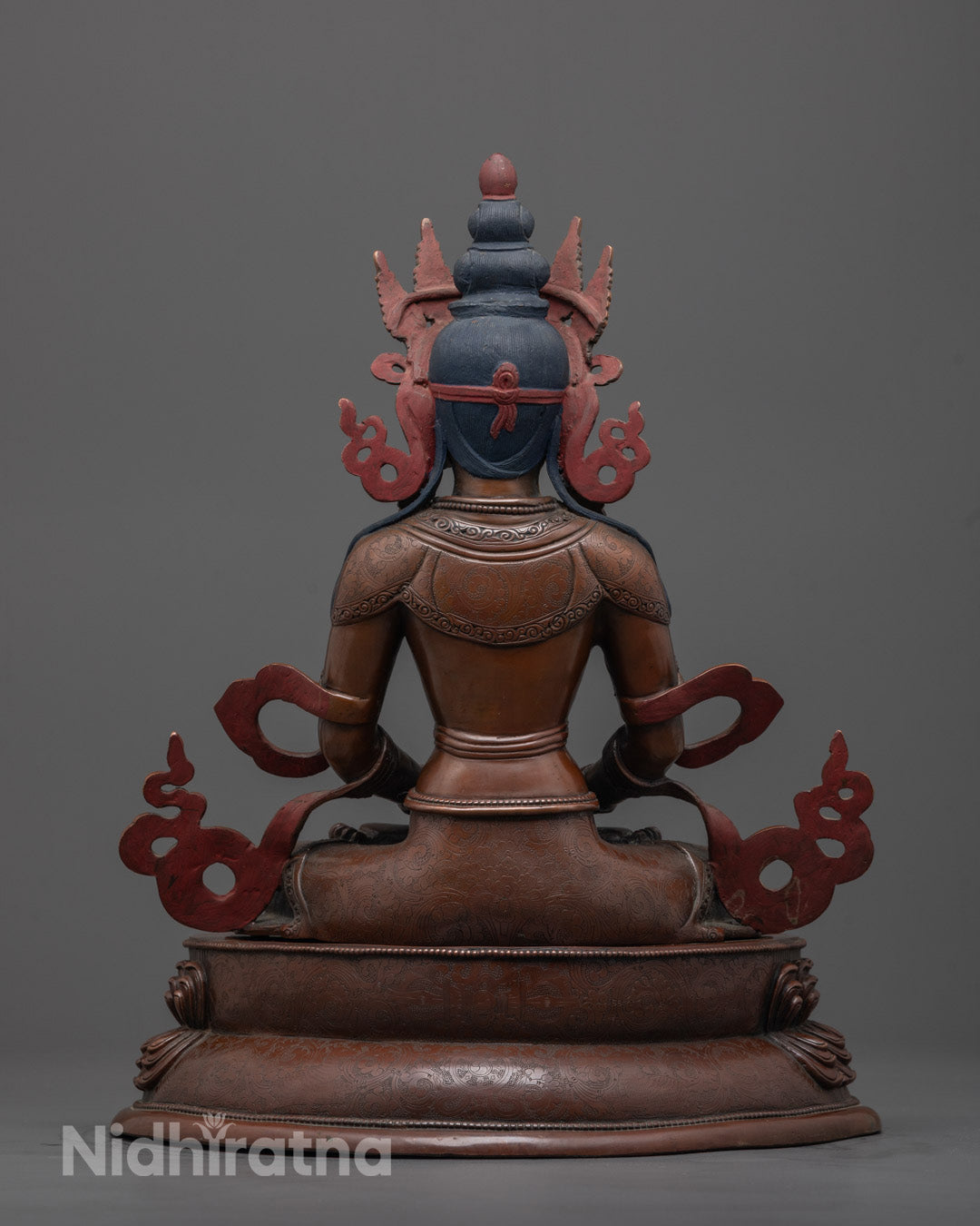 Back-view Artisan-crafted Amitayus Buddha statue displayed on a wooden altar