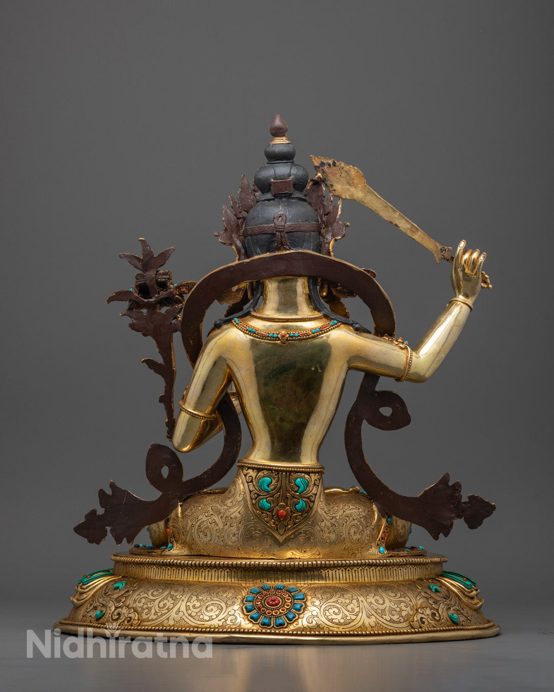 Back View of Handcrafted Manjushri Statue Highlighting Robe, Lotus Throne and Gemstone Details