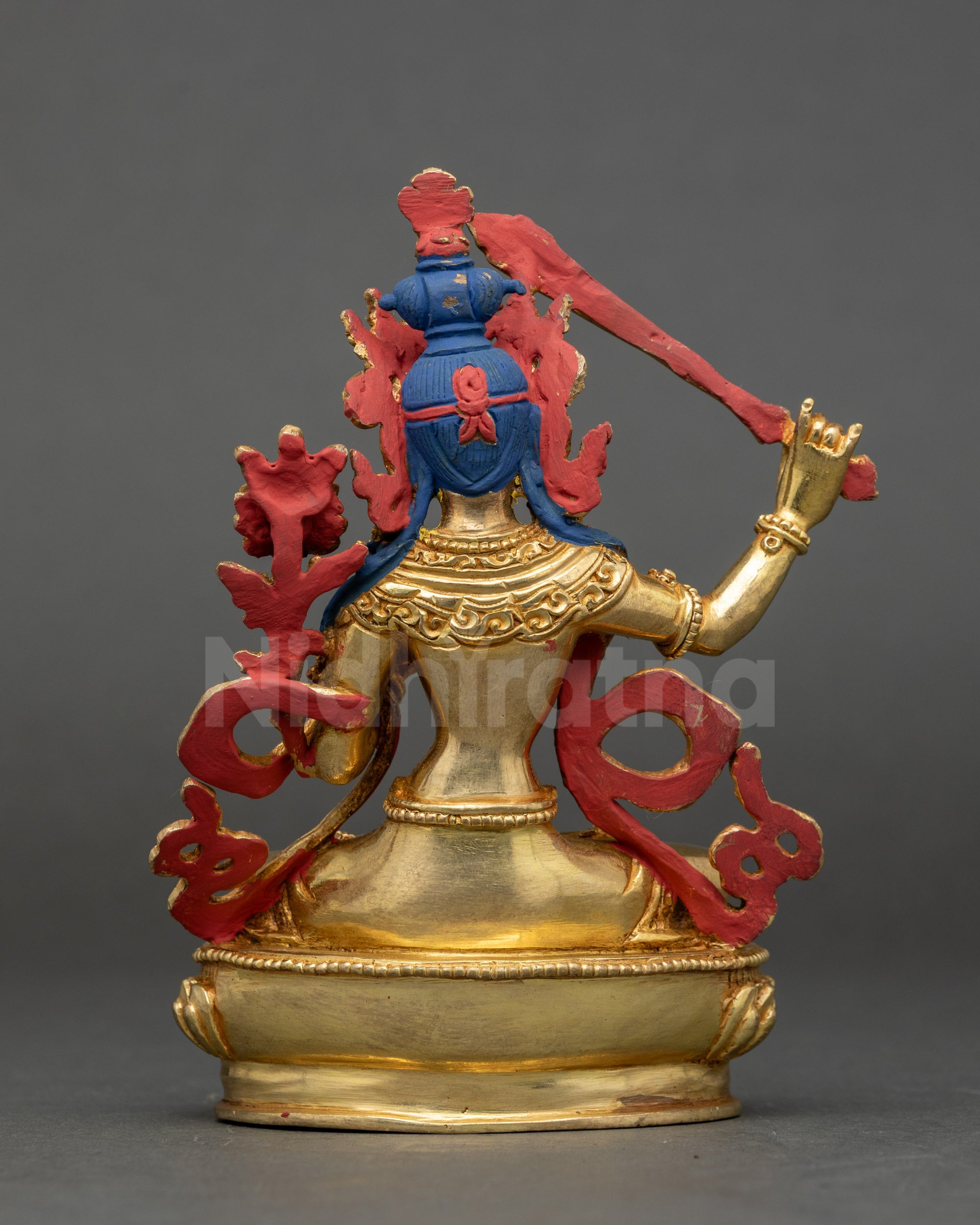 Back of Himalayan Manjushri Statue showing intricate robe carvings and crown
