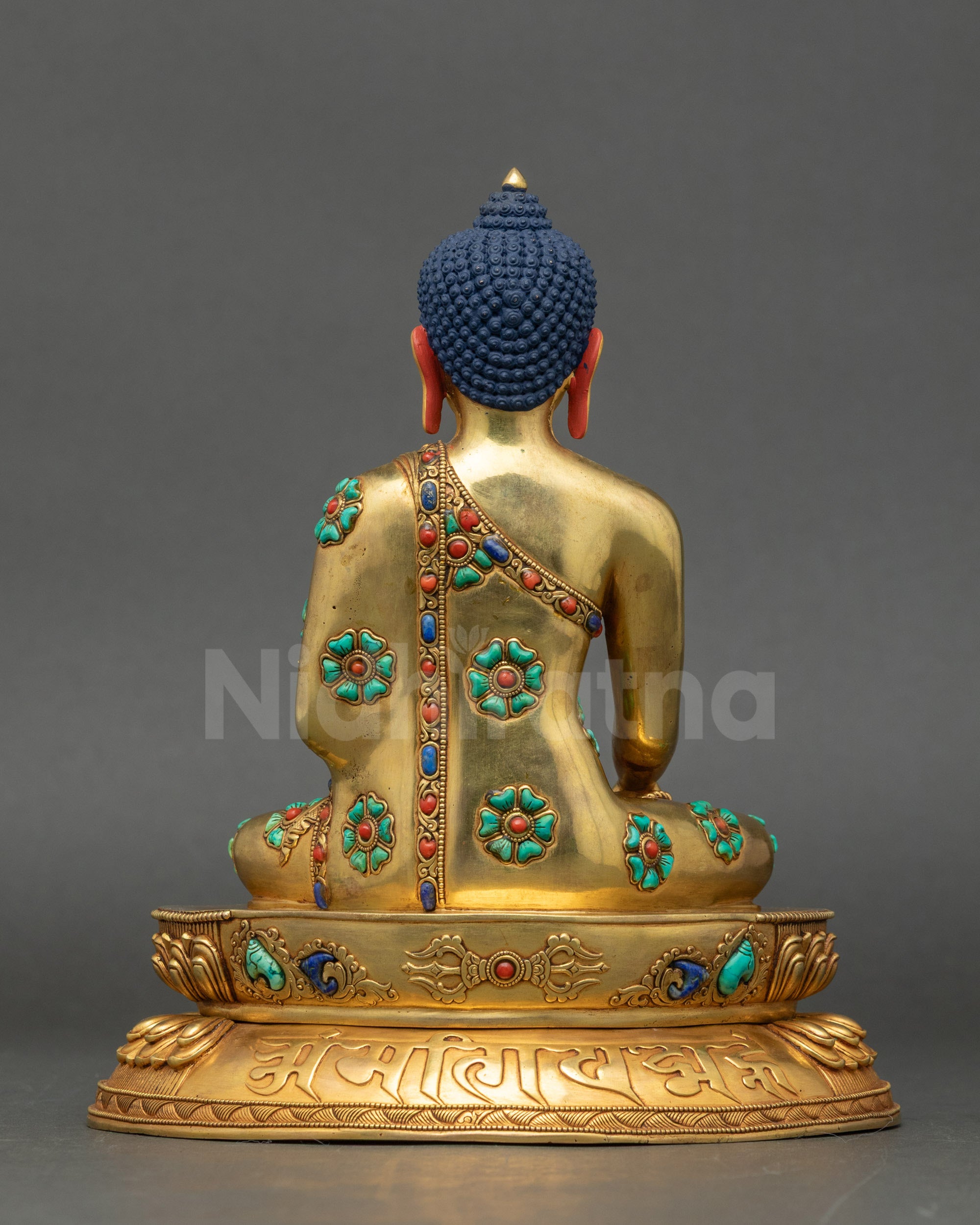 Back of Shakyamuni Buddha Statue showing detailed carvings and semi-precious stone embellishments