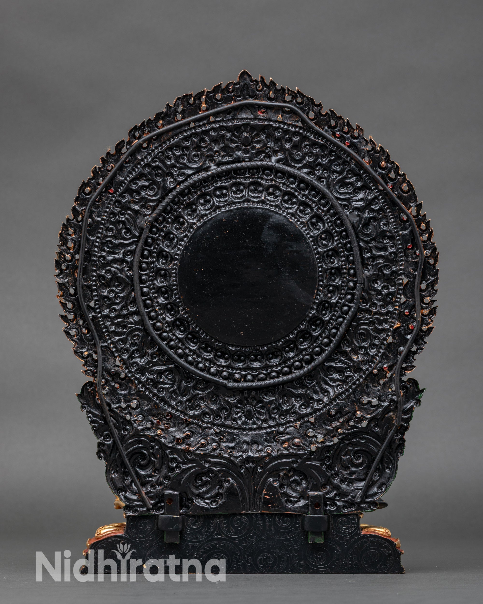 Back of Vajrayogini statue showing engraved lotus seat and flame halo