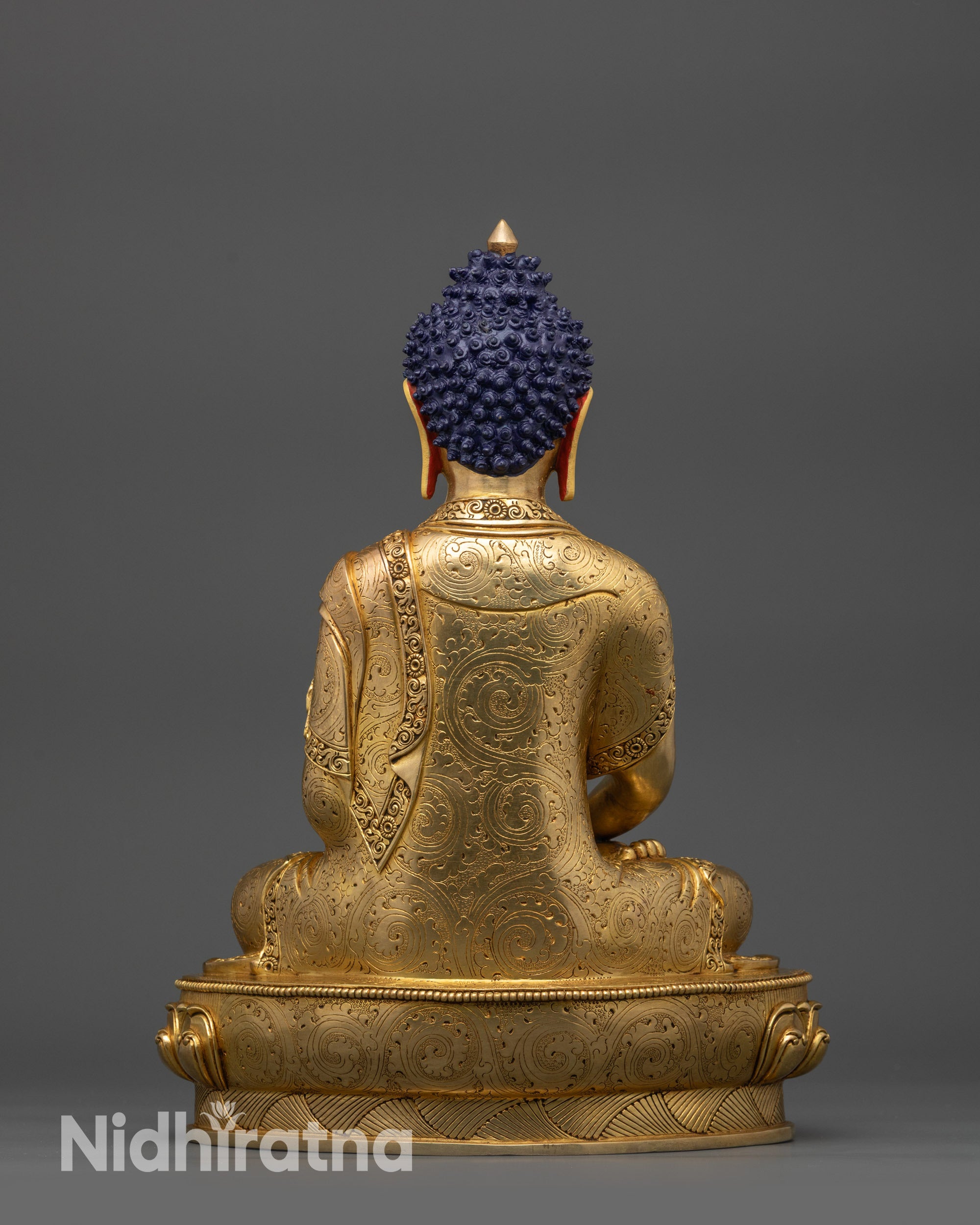 Back view Amitabha Buddha showing intricate carved monk's robe patterns