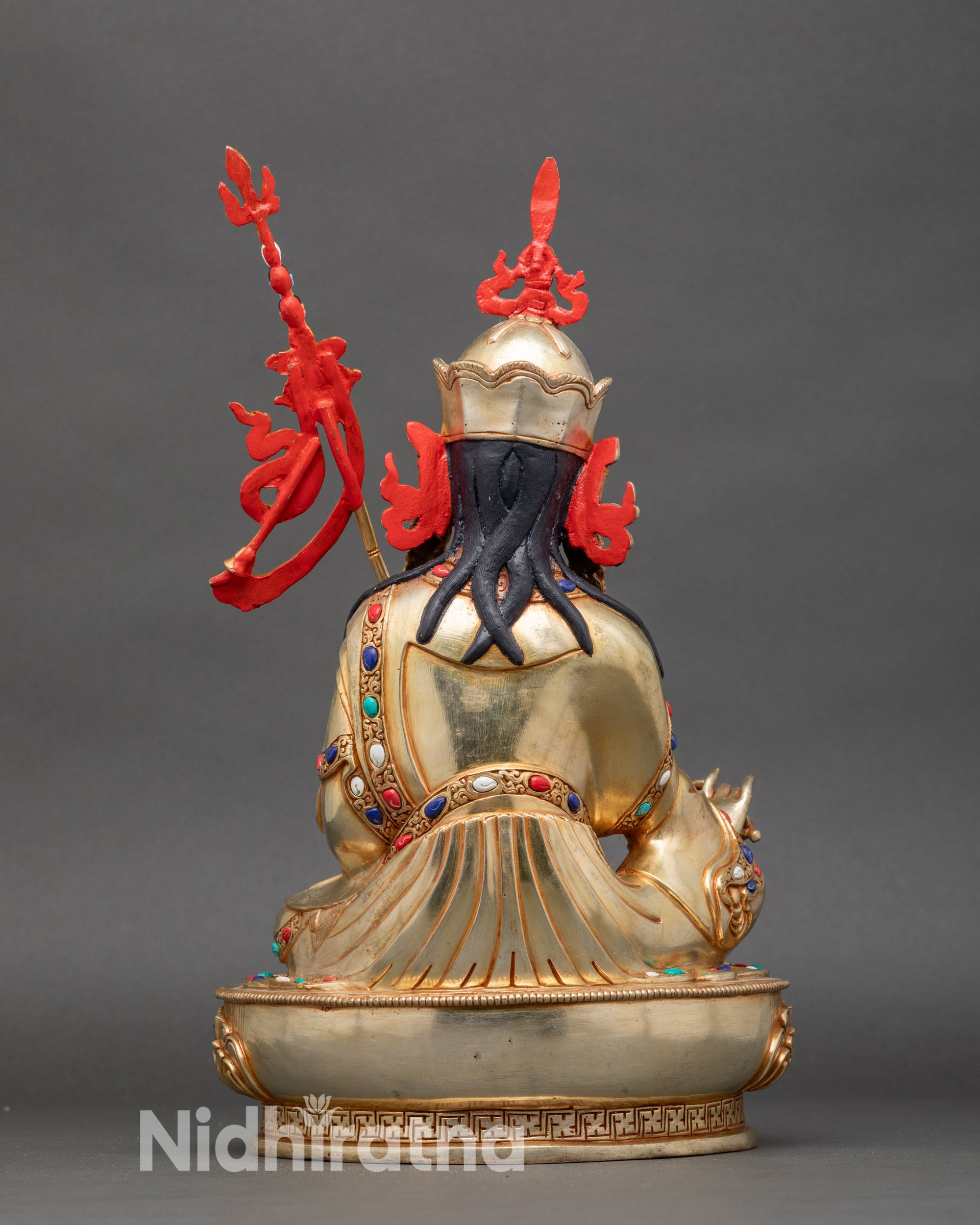 Back view: Back view of Guru Rinpoche statue showing detailed lotus pedestal and flowing robes