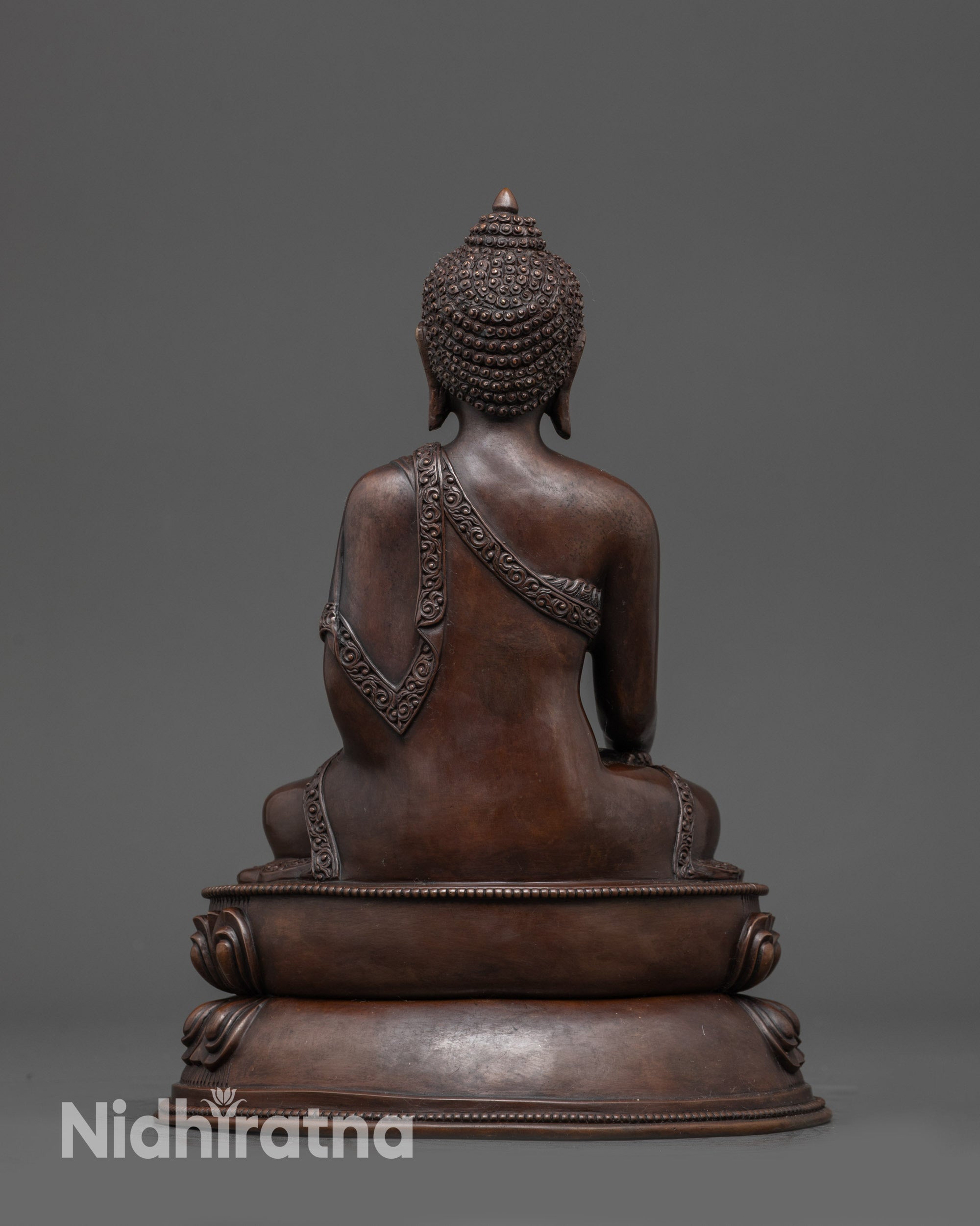 Back view: Back view of Shakyamuni Buddha showing double-layered lotus and robe details