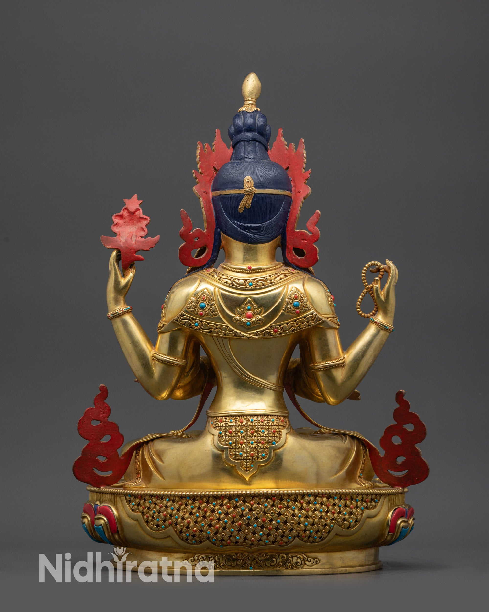 Back view Chenrezig statue highlighting intricately carved lower garments and patterns