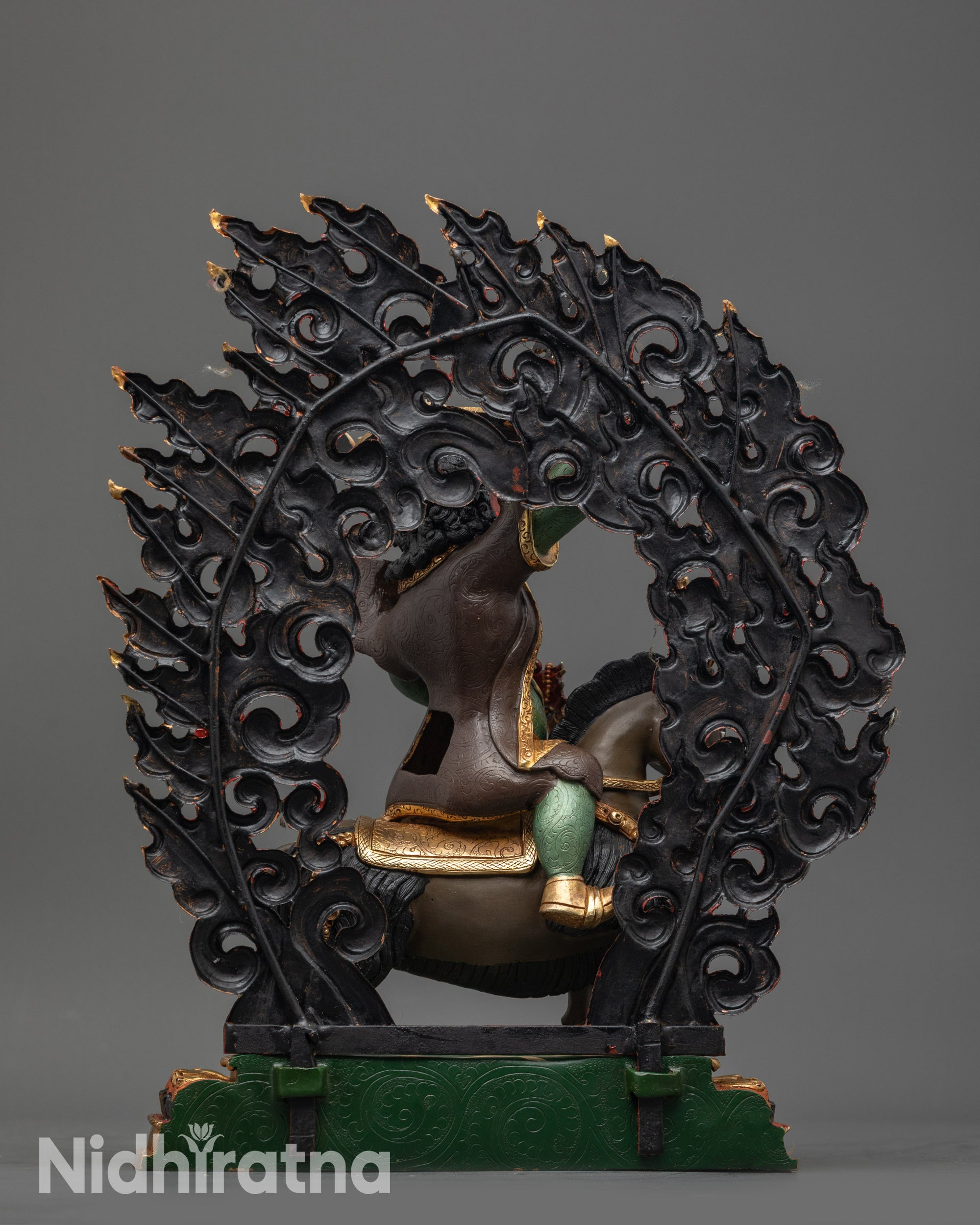 Back view Damchen Garwa Nagpo showing warrior garments and gold silver hat