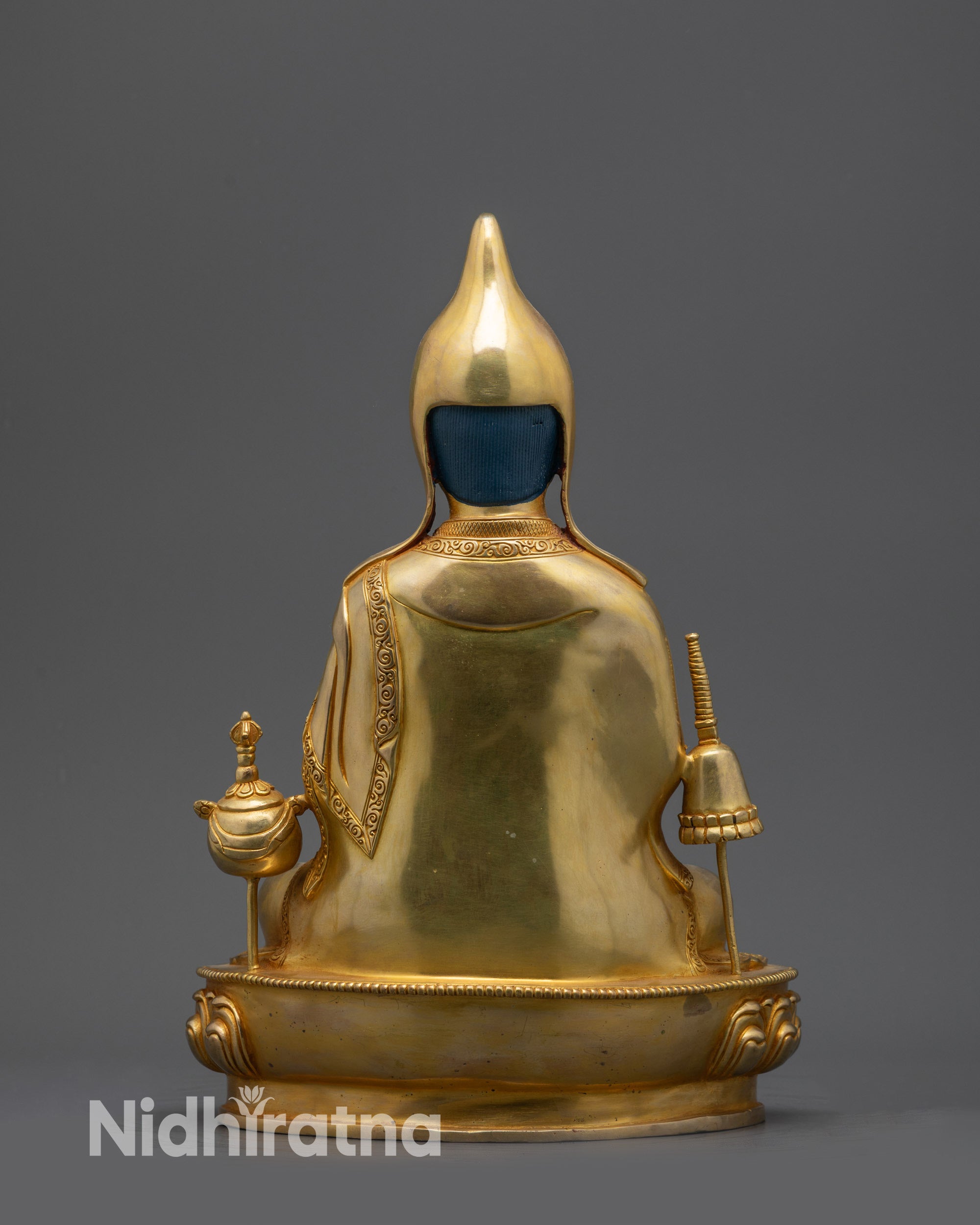 Back view Dipankara Atisha statue showing intricate robe and garment carvings