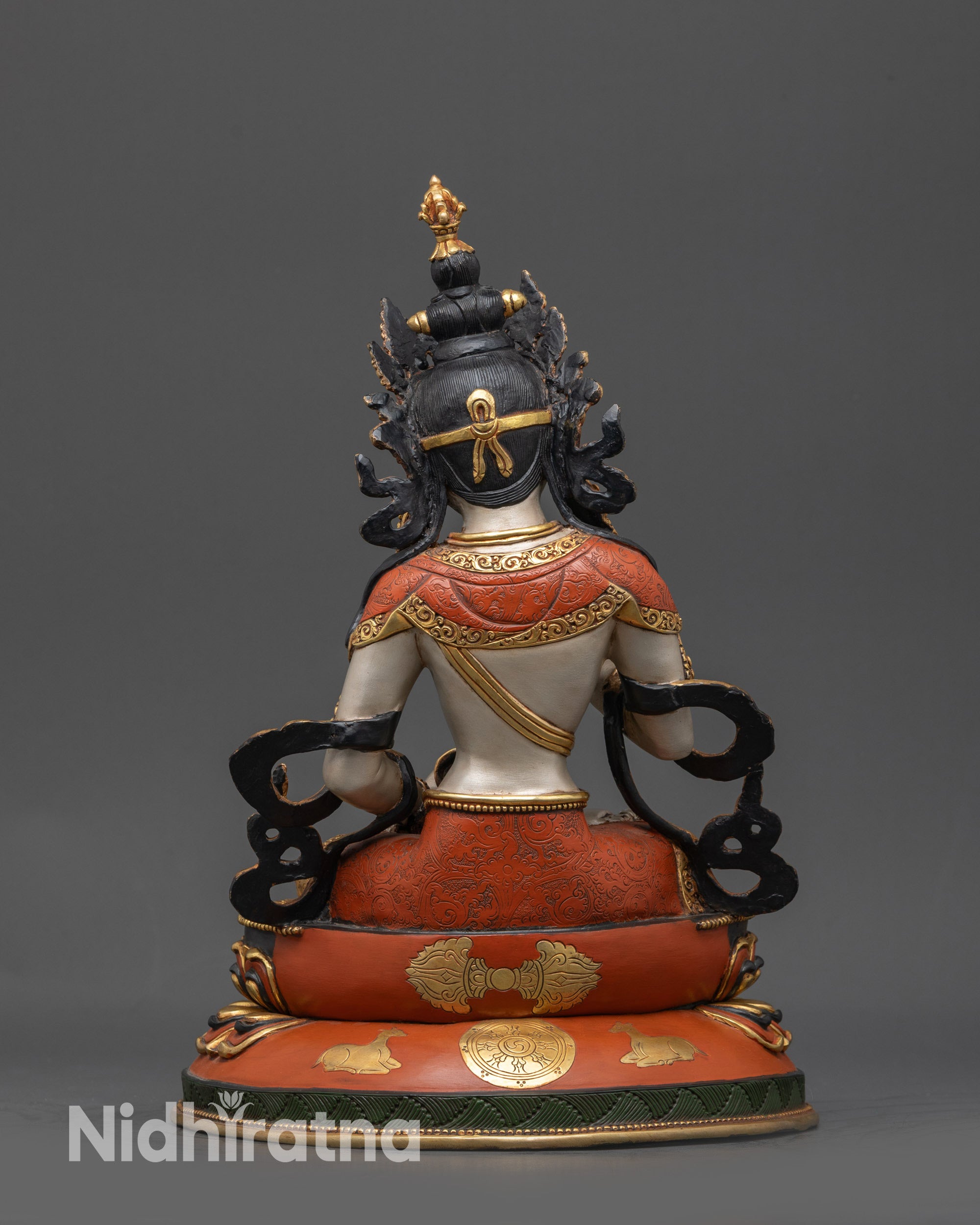 Back view Dorje Sempa statue on lotus seat showing dharma wheel and deer carvings in detail