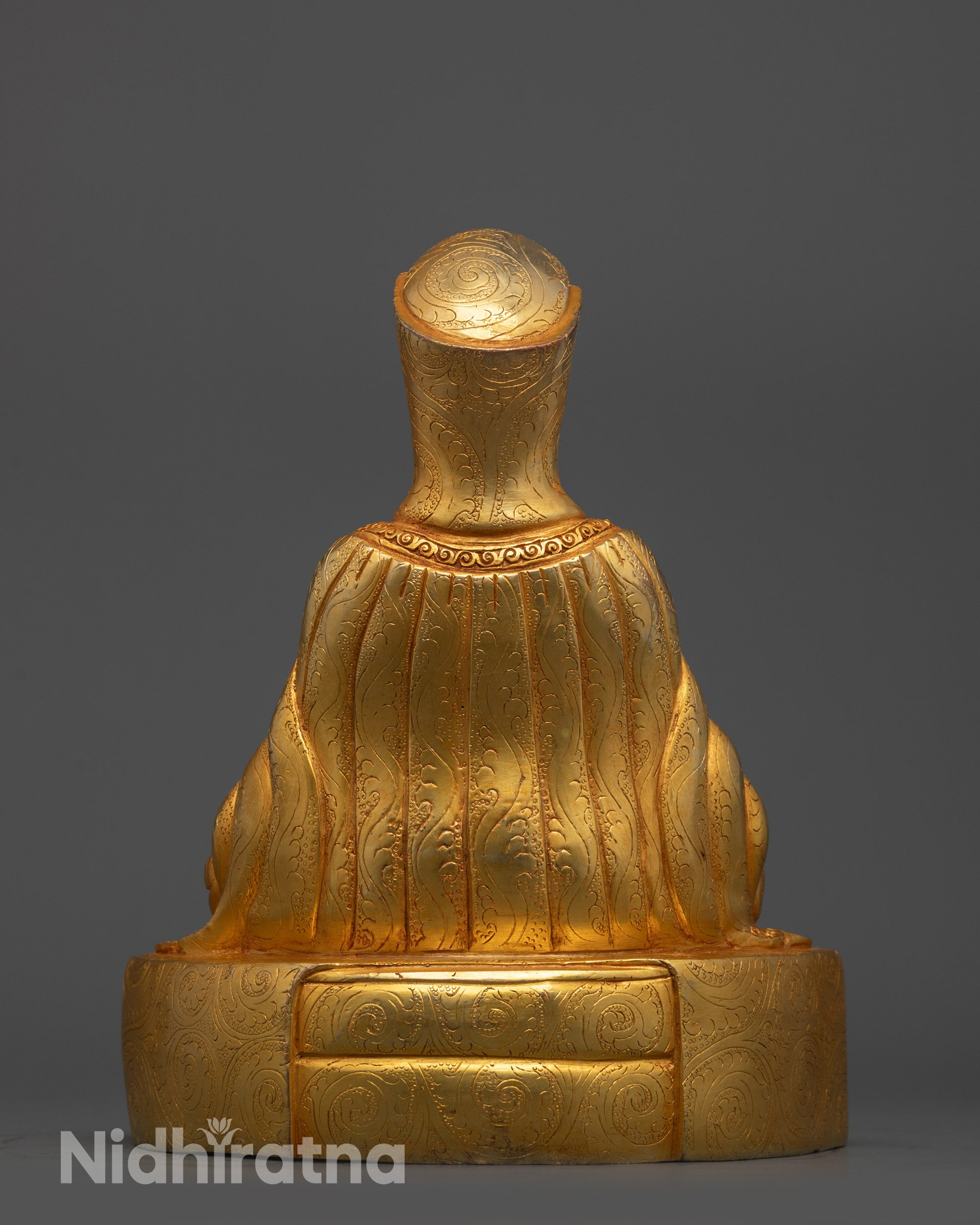 Back view Gampopa Statue with intricate robe carvings and gold fire gilded copper base