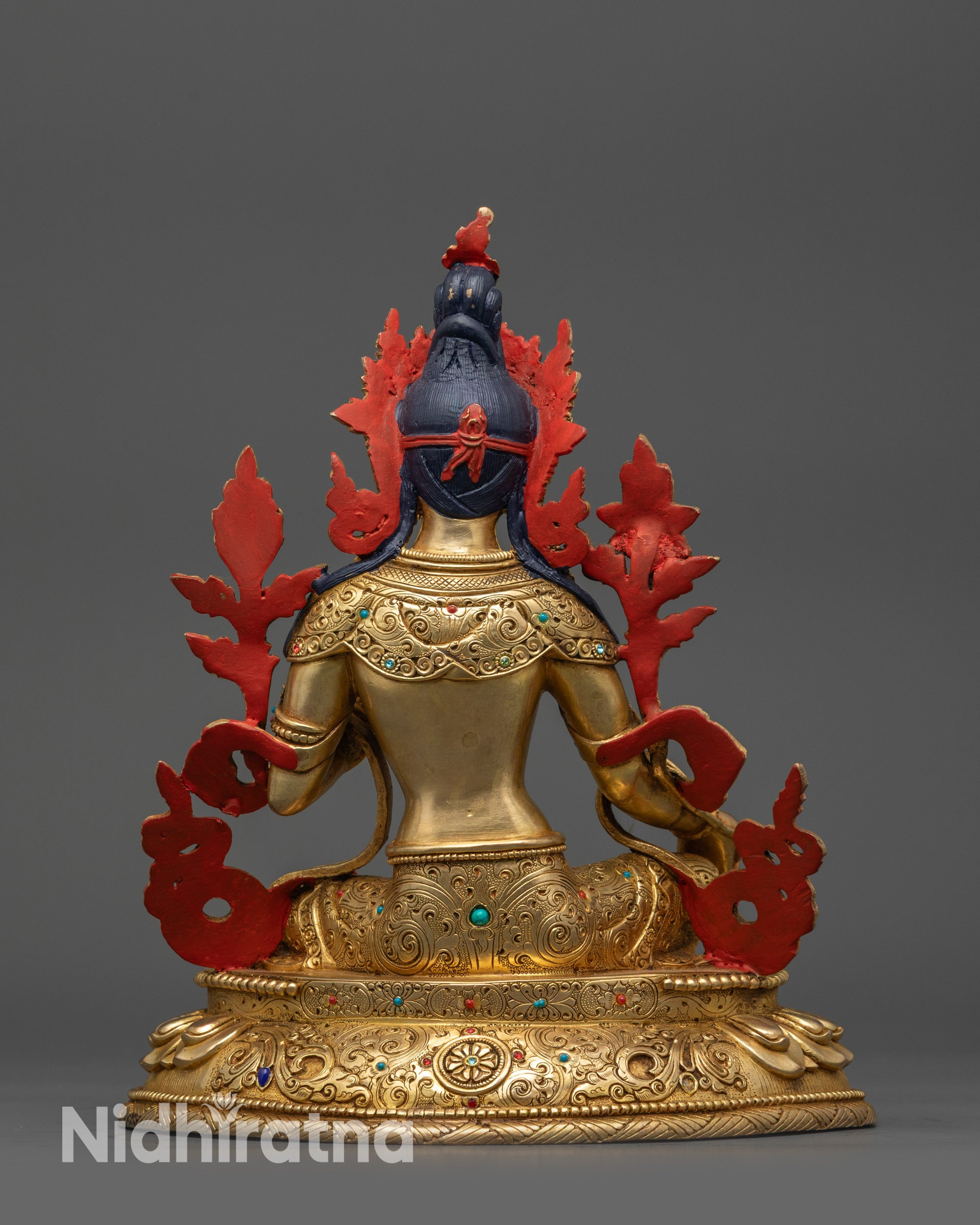Back view Green Tara statue highlighting detailed patterns on lotus seat and robes