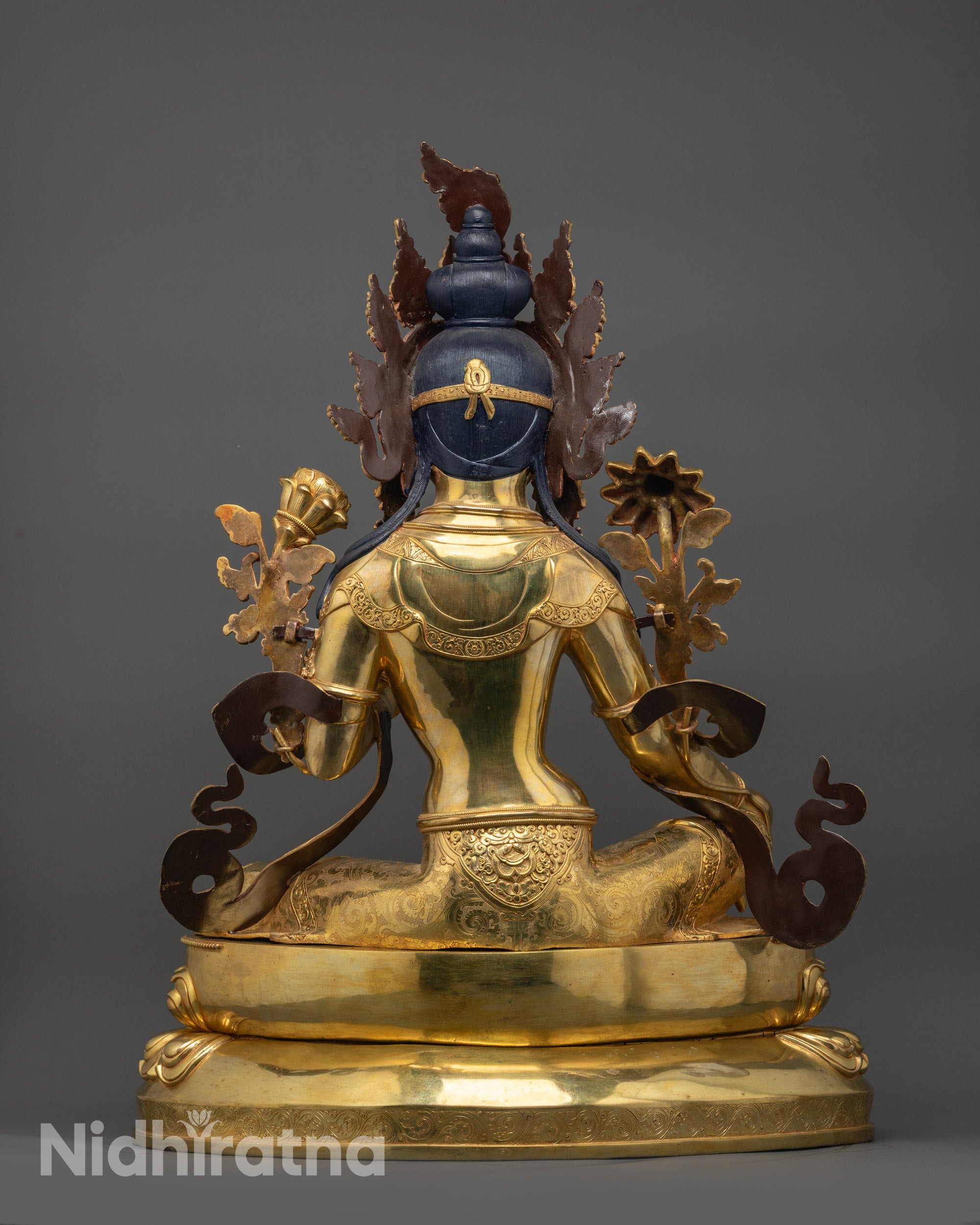 Back view Green Tara statue highlighting intricate robe patterns and copper-gilded detailing
