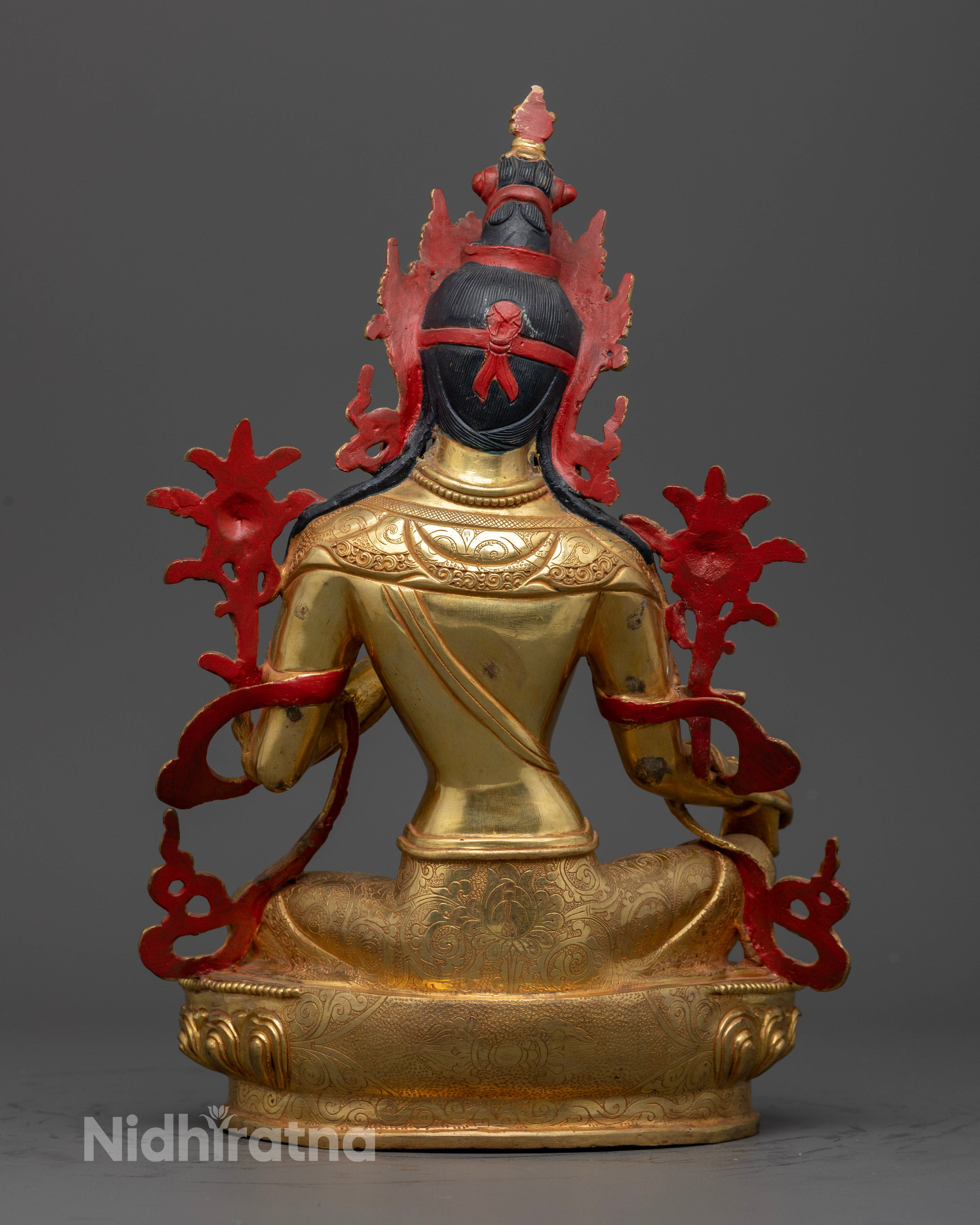 Back view Green Tara statue with detailed garments and lotus pedestal, traditional Nepalese Buddhist artwork