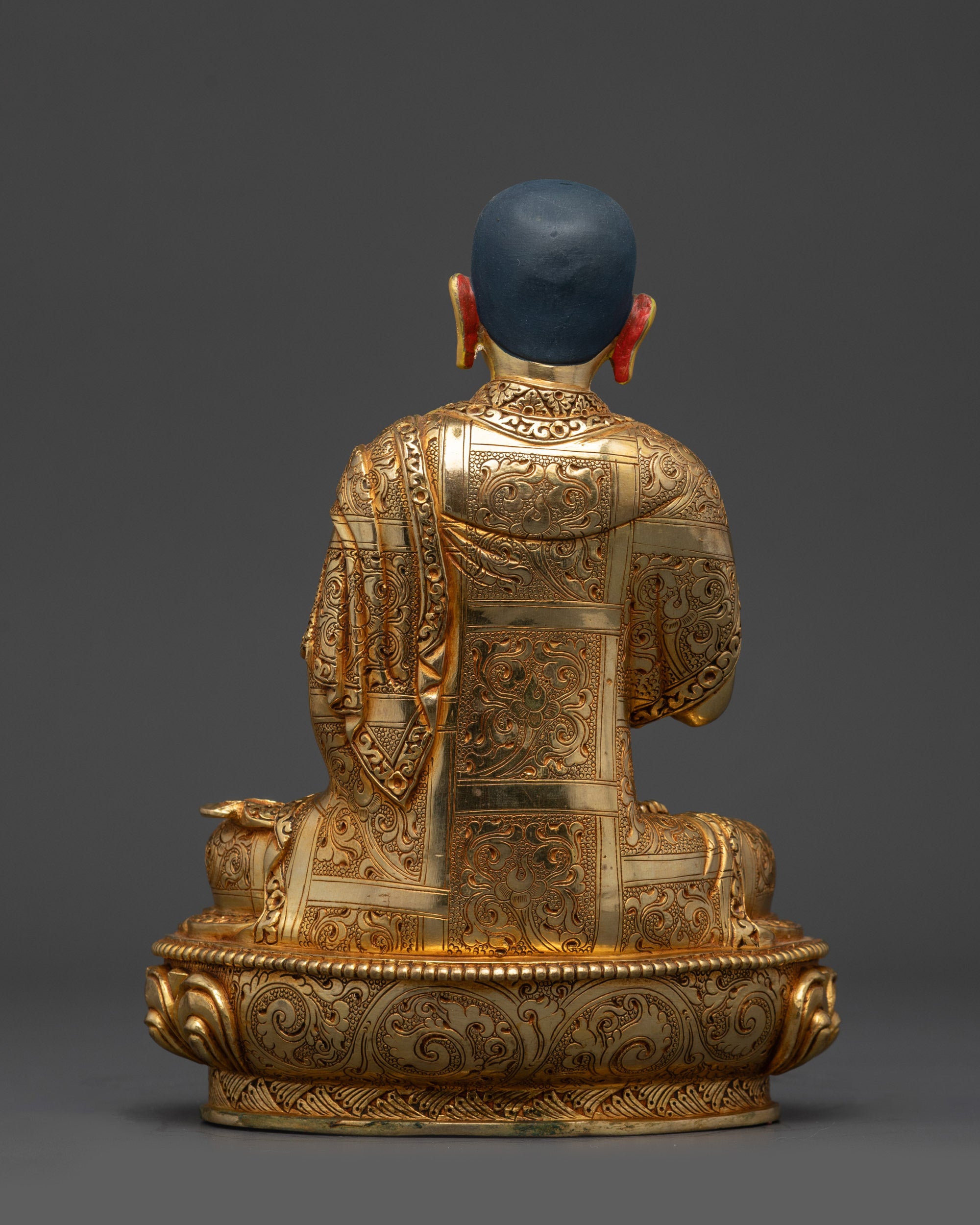 Back view Khedrup Je statue highlighting detailed carvings and lotus pedestal