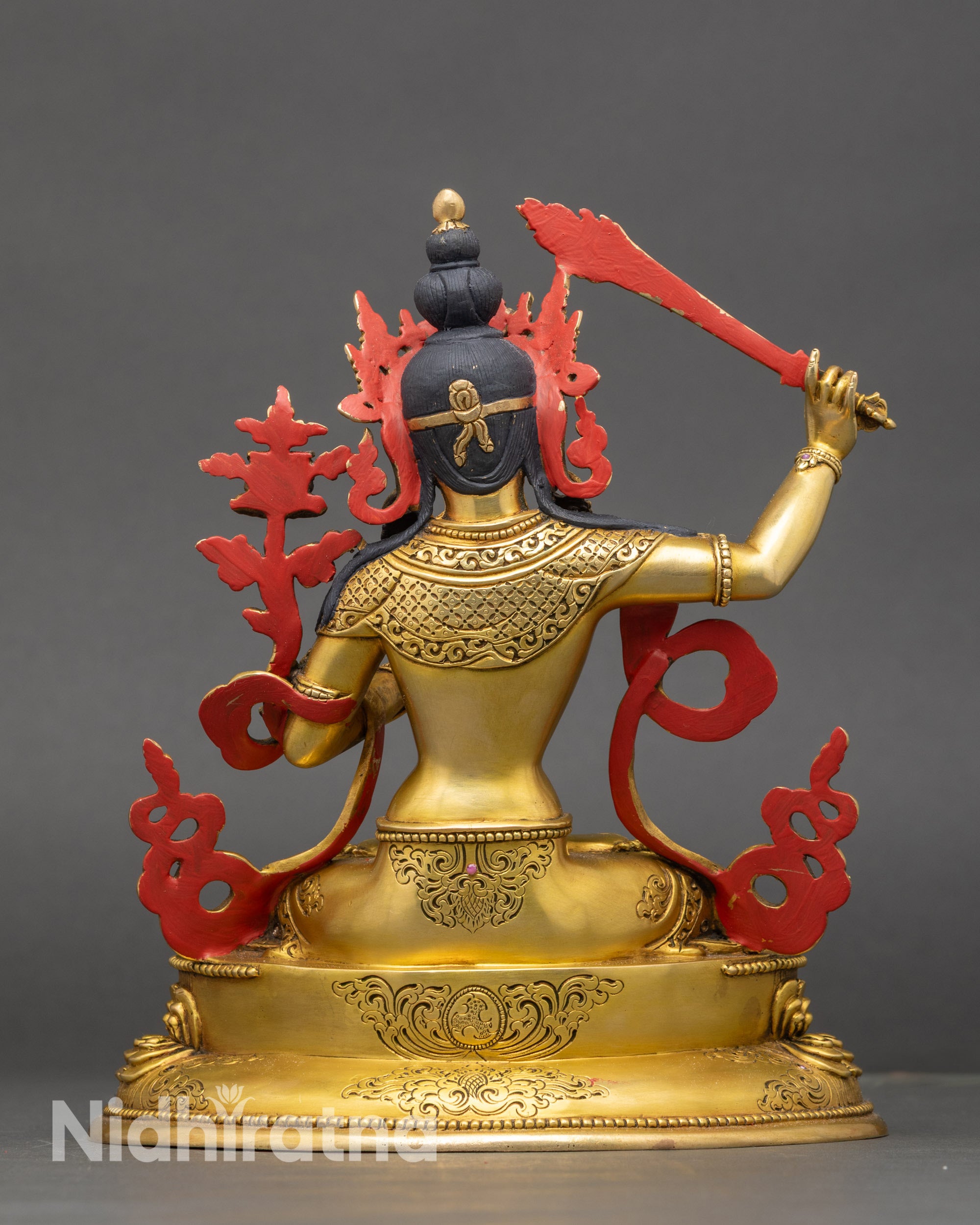 Back view Manjushri copper statue intricate carvings and ornate jewelry on lotus base