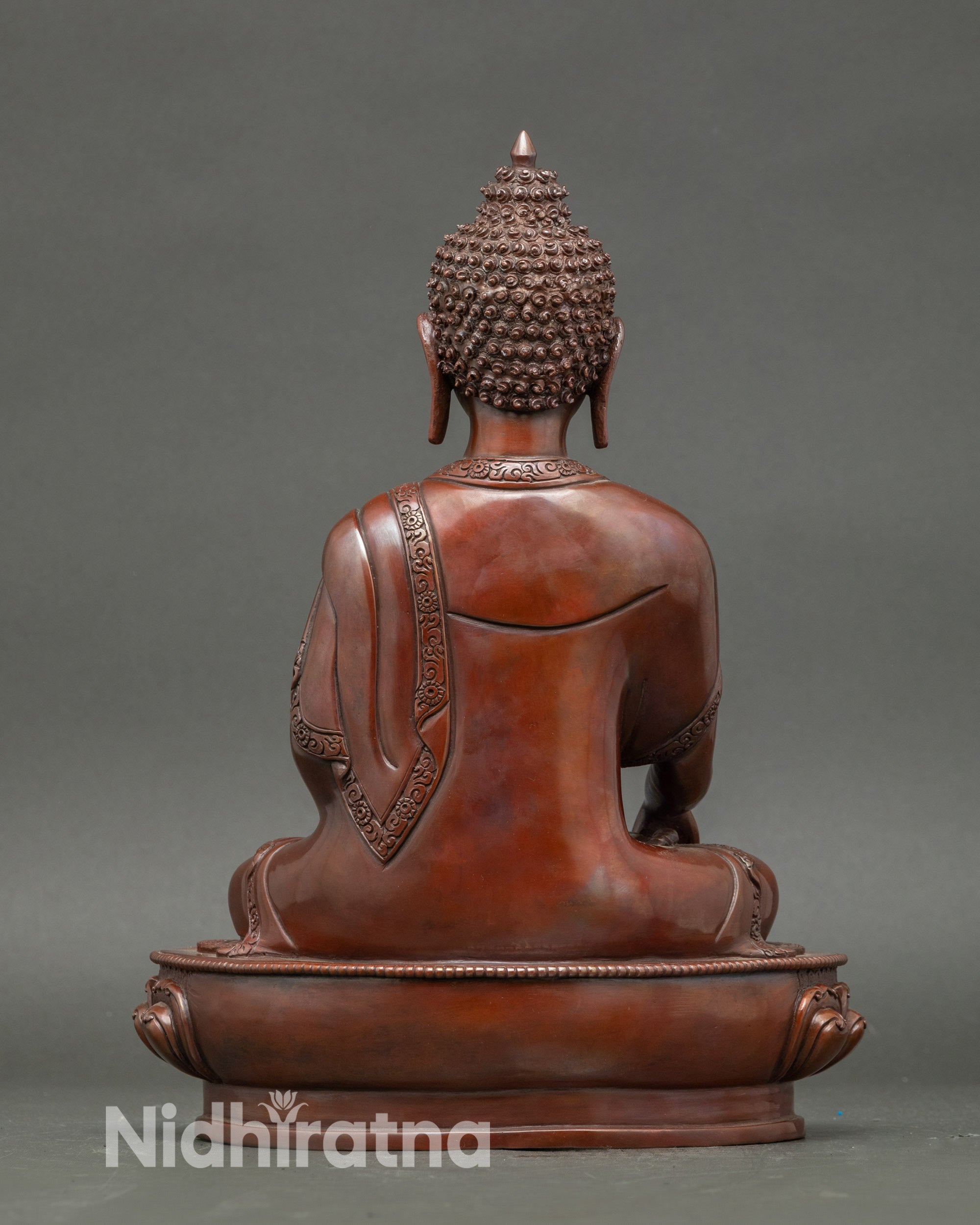 Back view Shakyamuni Buddha sculpture highlighting flowing robes and Newari artistry