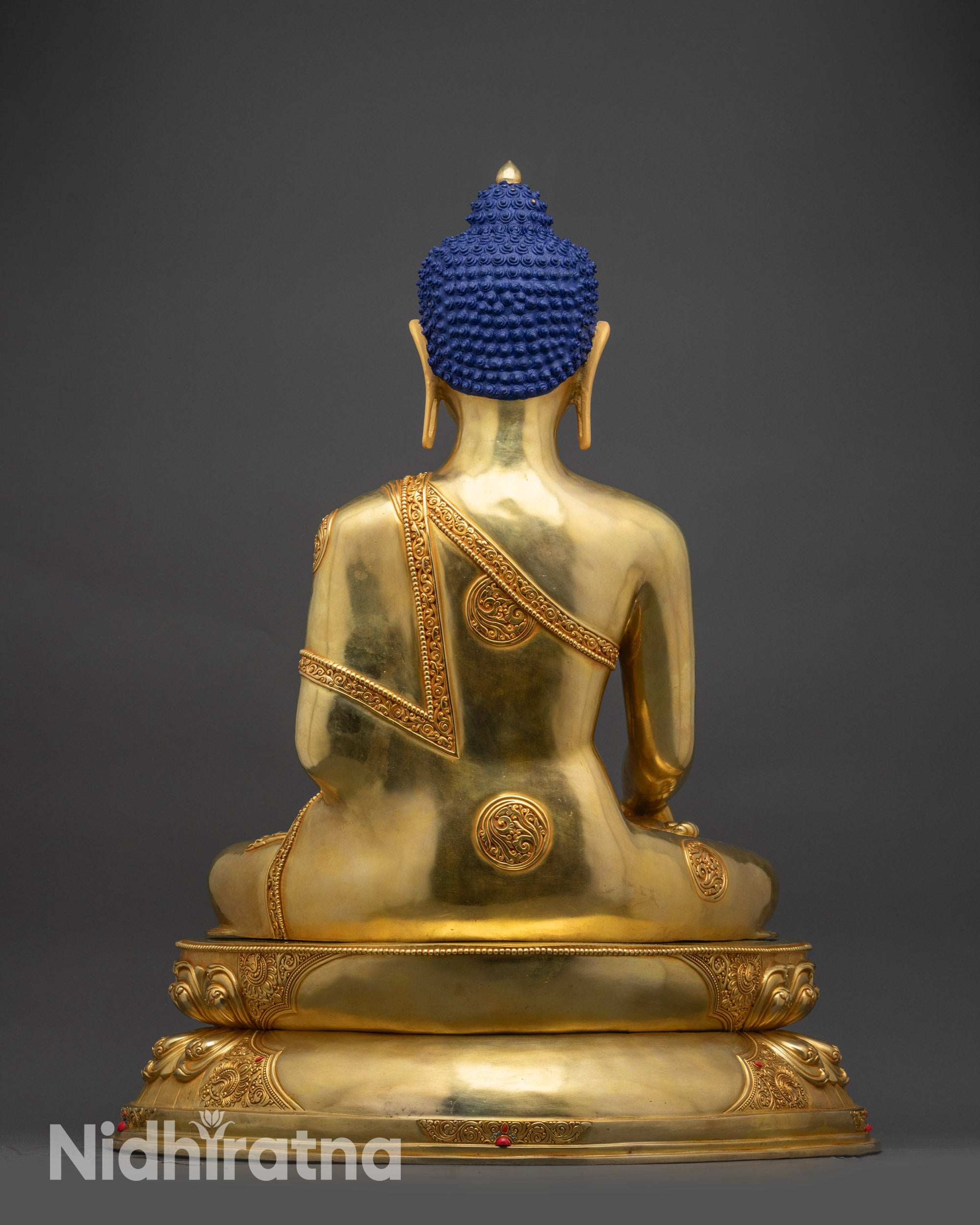 Back view Shakyamuni Buddha statue displaying sculpted robes and meditation base