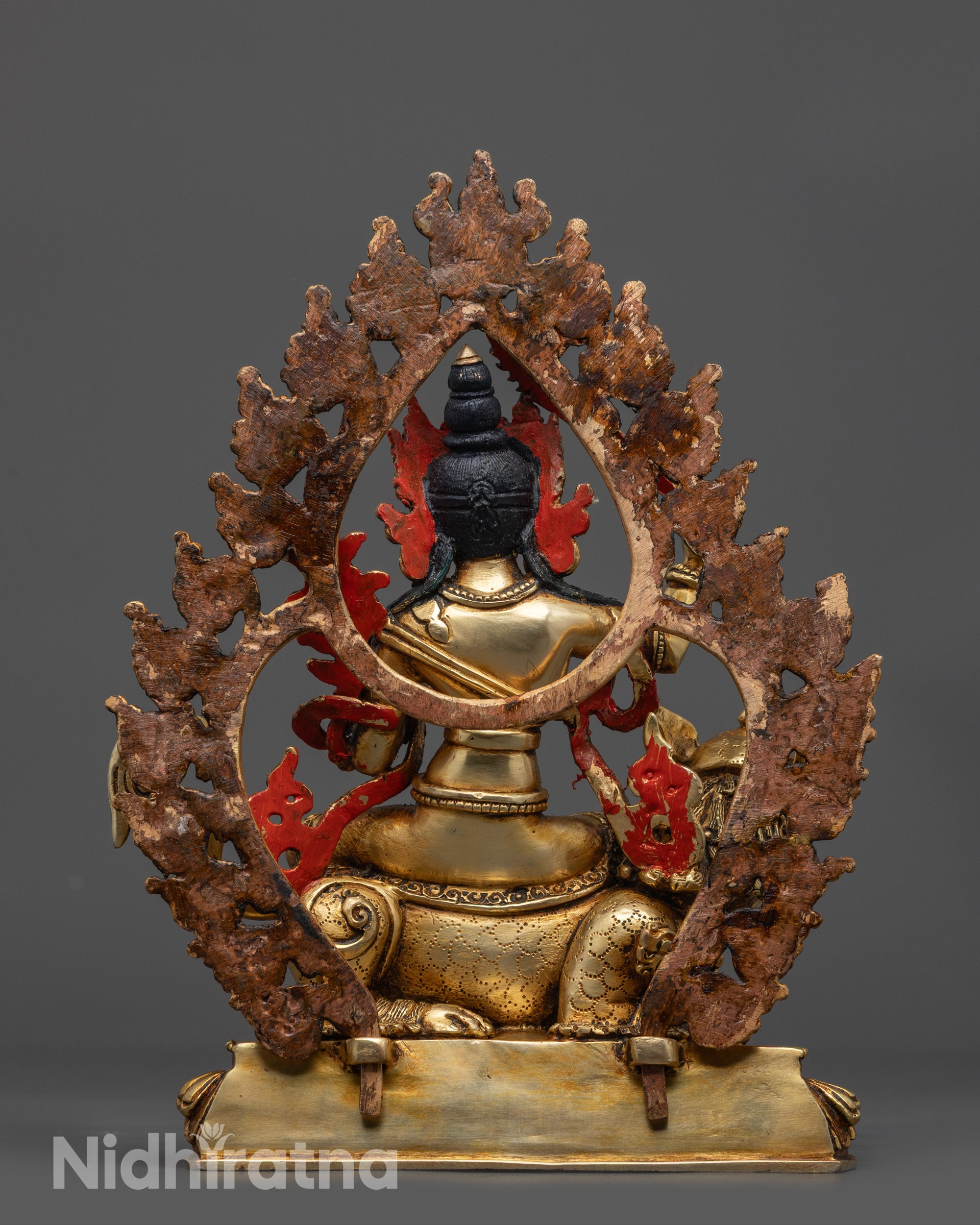 Back view Simhada Manjushri Statue showing halo and detailed sacred motifs on copper base