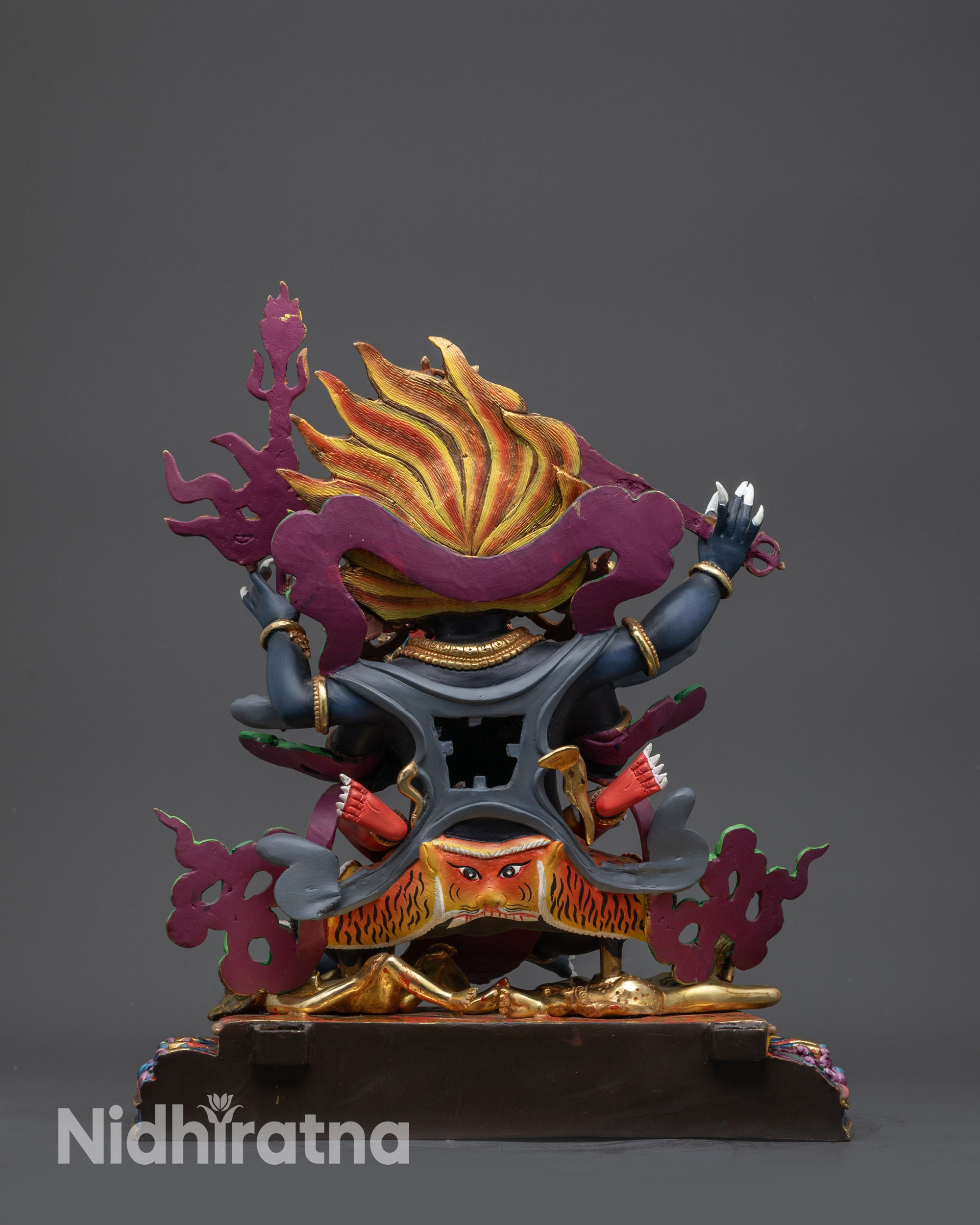 Back view Tibetan Mahakala Statue displaying detailed robe and patterned jewelry